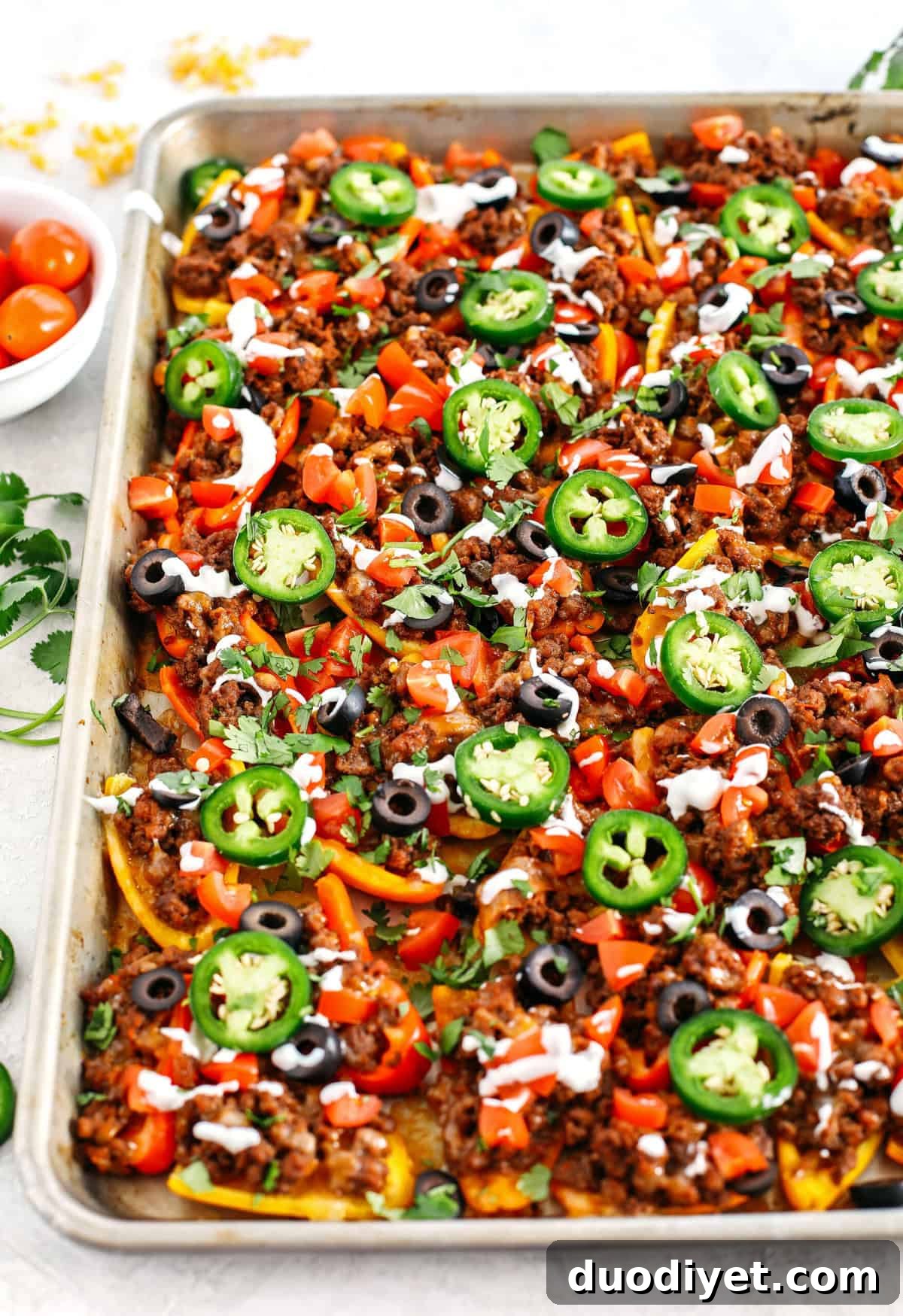 These Sheet Pan Loaded Bell Pepper Nachos are packed with all your favorite flavors and fun toppings making them the perfect low carb appetizer to enjoy on game day!
