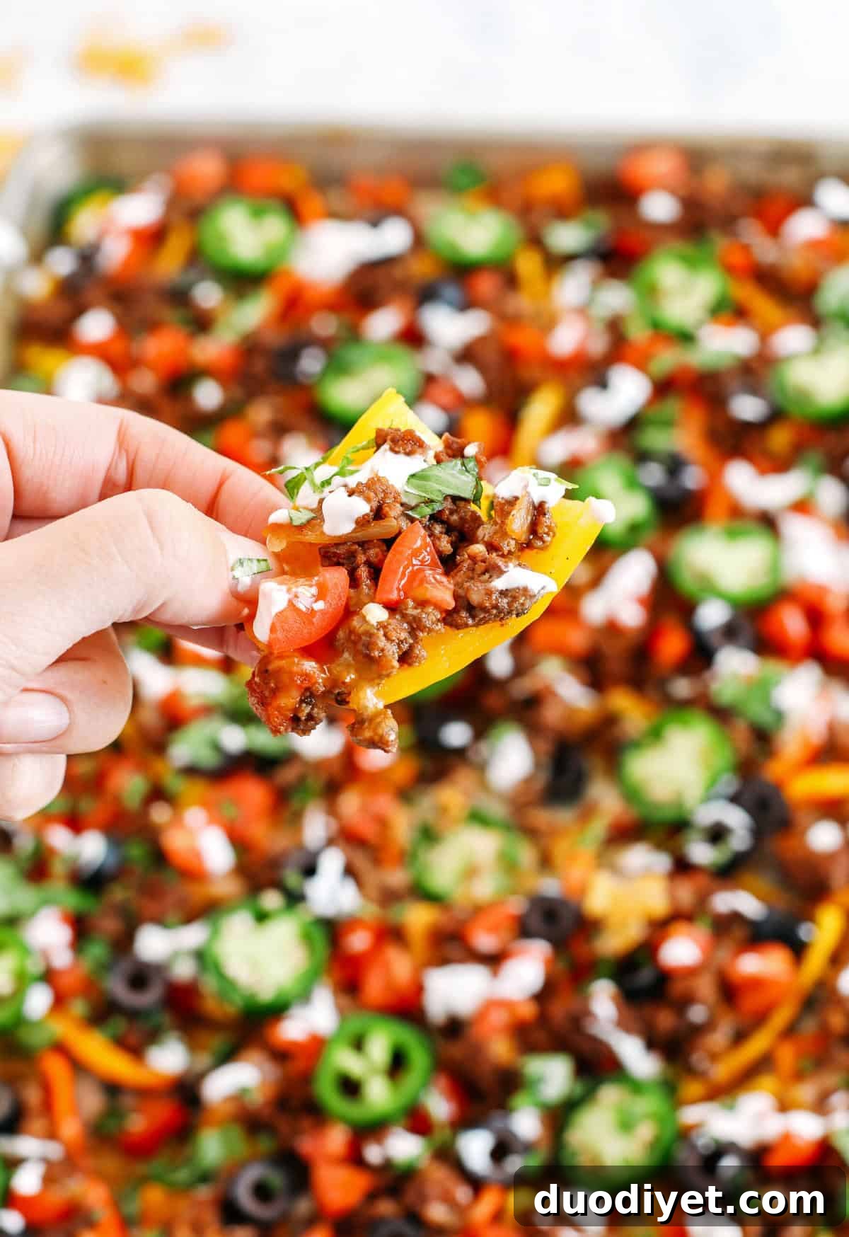 These Sheet Pan Loaded Bell Pepper Nachos are packed with all your favorite flavors and fun toppings making them the perfect low carb appetizer to enjoy on game day!