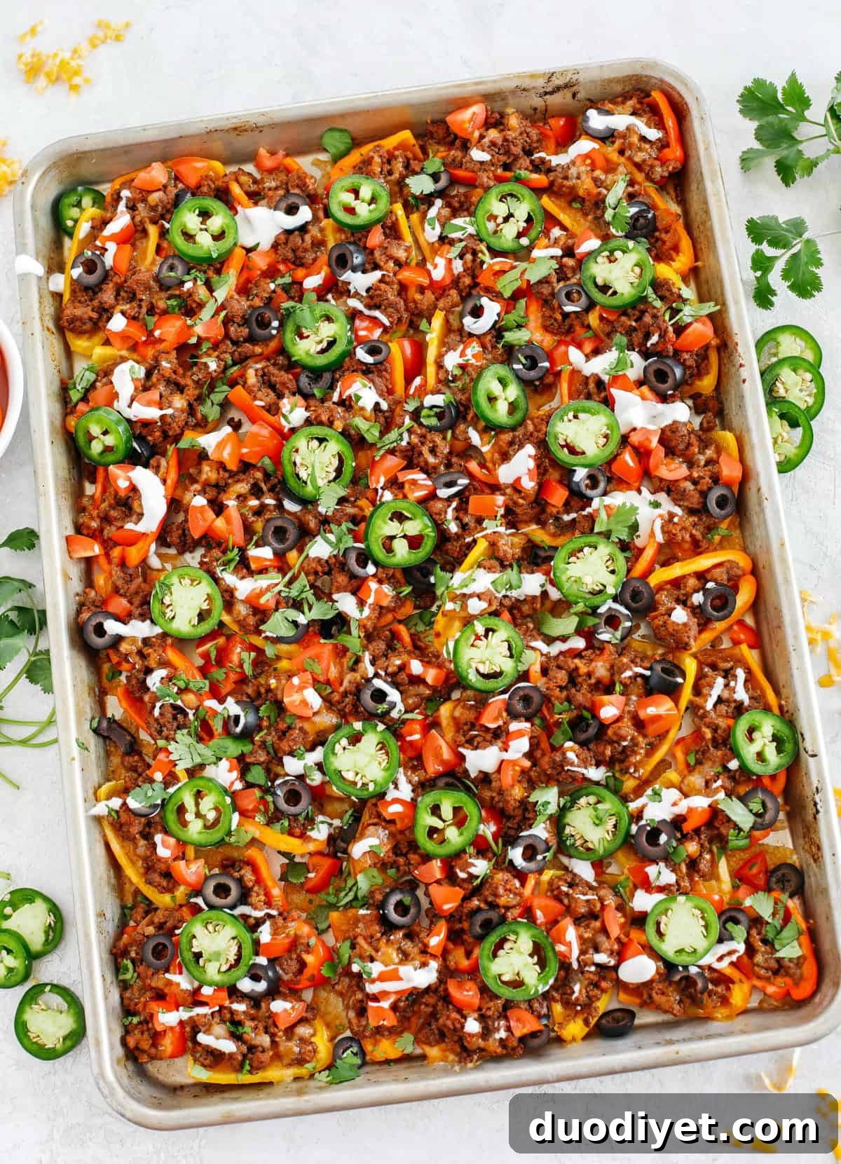 These Sheet Pan Loaded Bell Pepper Nachos are packed with all your favorite flavors and fun toppings making them the perfect low carb appetizer to enjoy on game day!