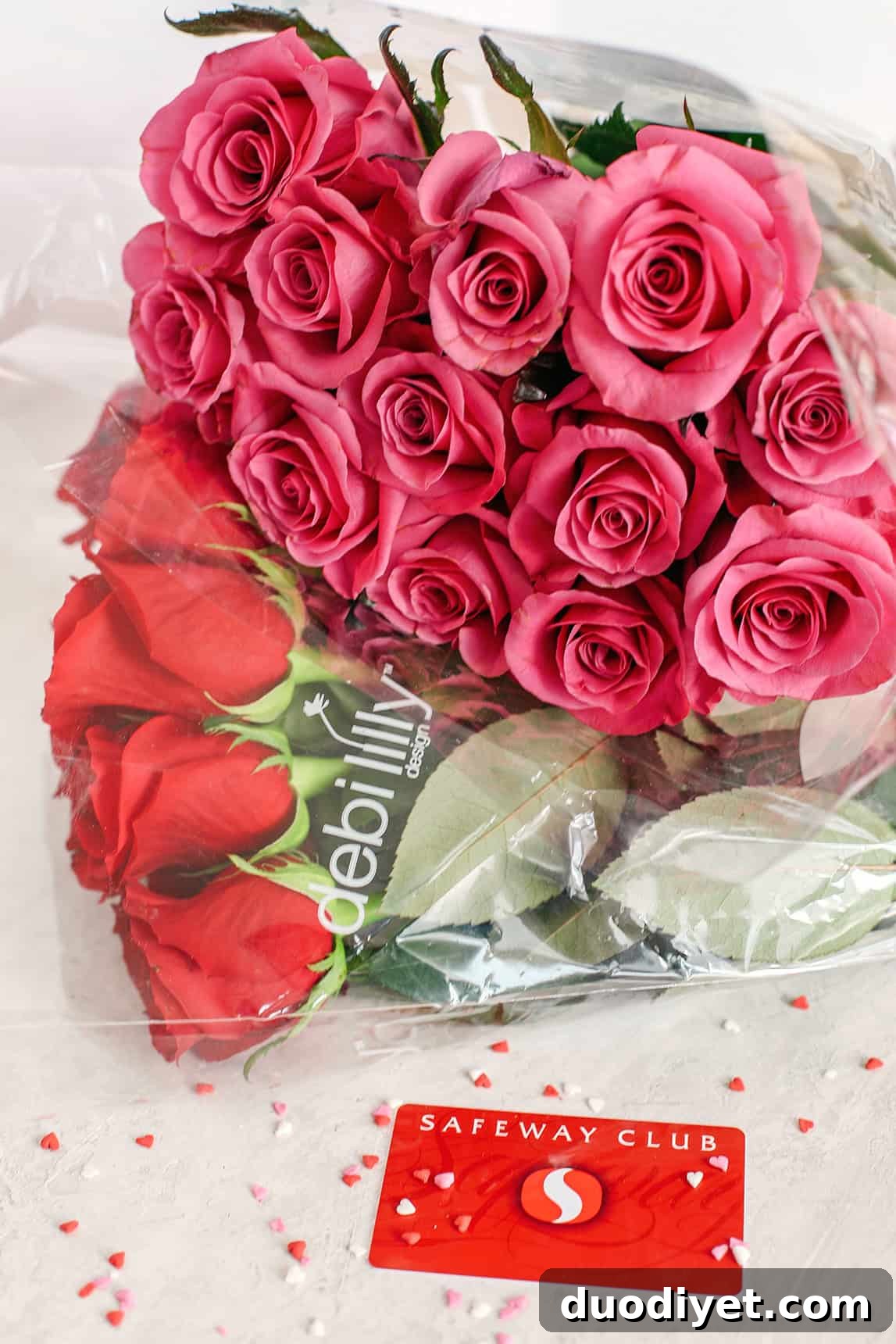 Celebrate Valentine's Day with a fun and festive dessert board made with healthier options like yogurt-dipped pretzels, chocolate covered almonds, fresh fruit and a honey yogurt dipping sauce!