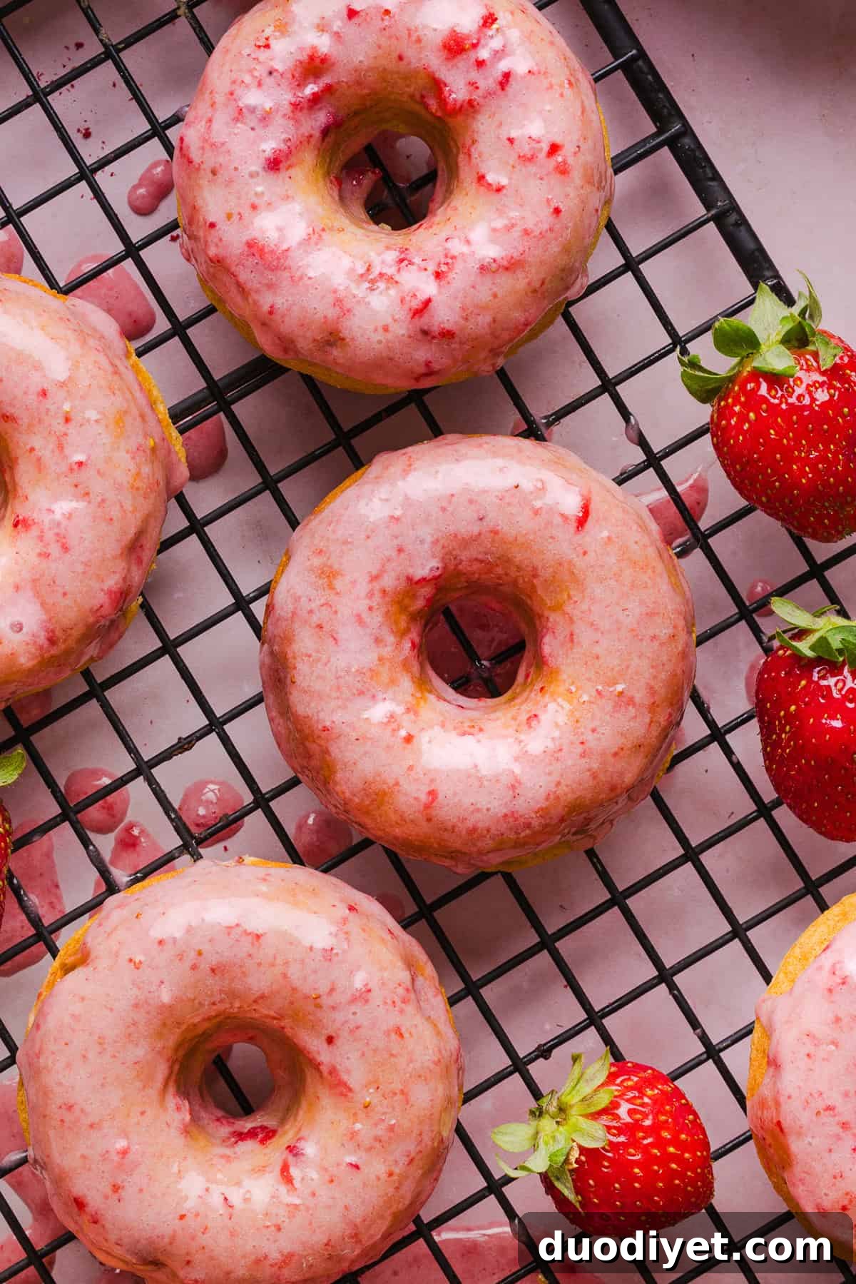 A plate of strawberry banana donuts