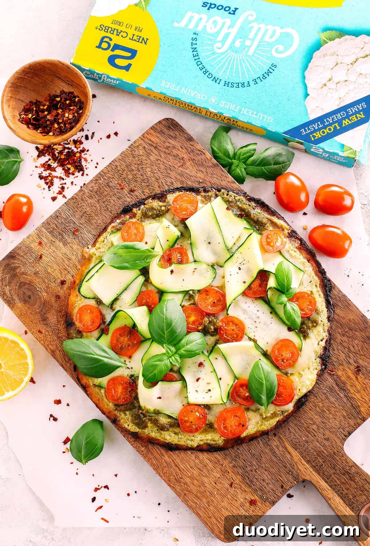Cauliflower Pizza with Fresh Garden Pesto 3 Garden Pesto Cauliflower Pizza loaded with fresh tomatoes, zucchini, homemade basil pesto and ricotta all topped on a crispy cauliflower crust for a delicious low carb meal in just 15 minutes!