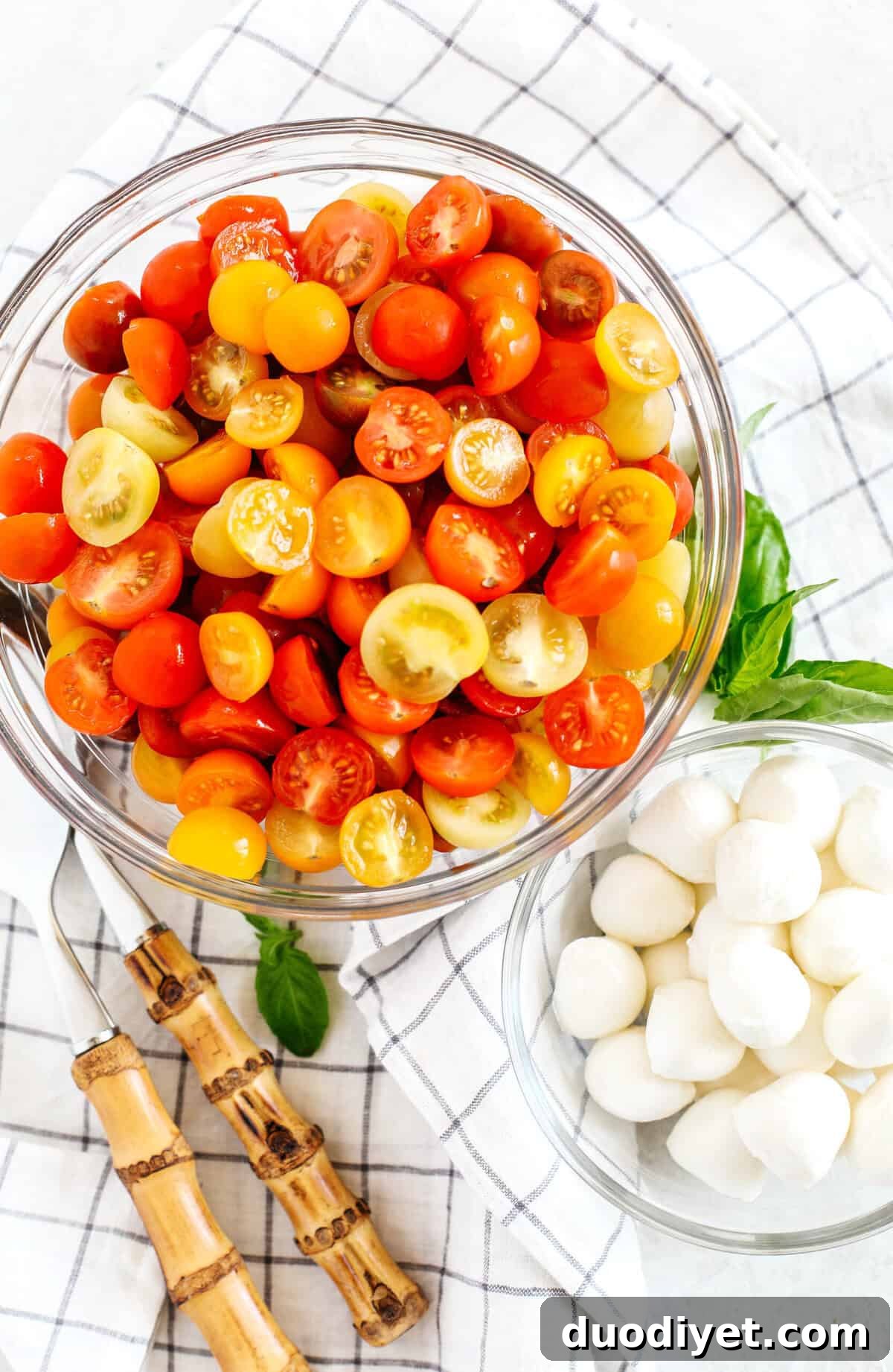 This Summer Caprese Salad is loaded with juicy tomatoes and creamy balls of mozzarella cheese all marinated in a delicious combination of olive oil, balsamic vinegar, garlic and fresh herbs!