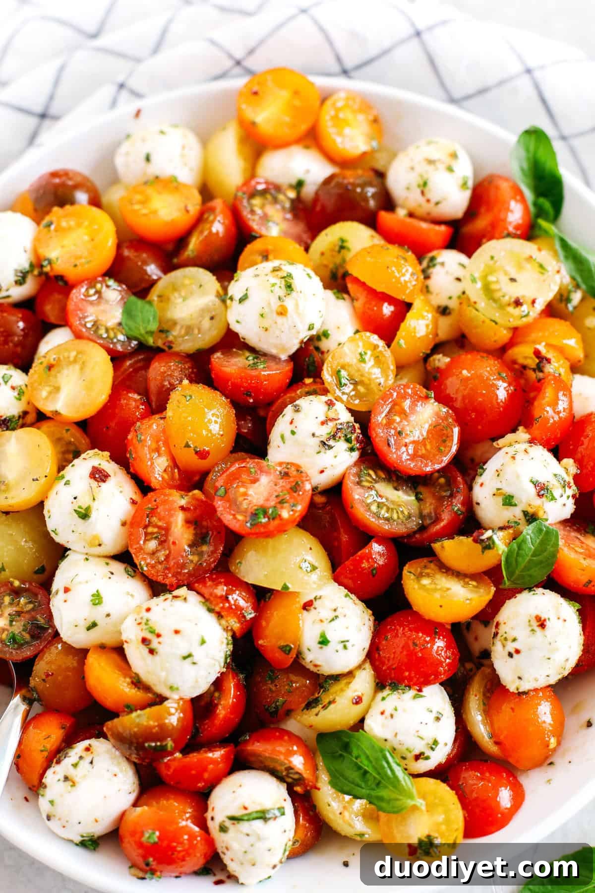 Marinated Summer Caprese with Heirloom Tomatoes and Fresh Basil 4 This Summer Caprese Salad is loaded with juicy tomatoes and creamy balls of mozzarella cheese all marinated in a delicious combination of olive oil, balsamic vinegar, garlic and fresh herbs!
