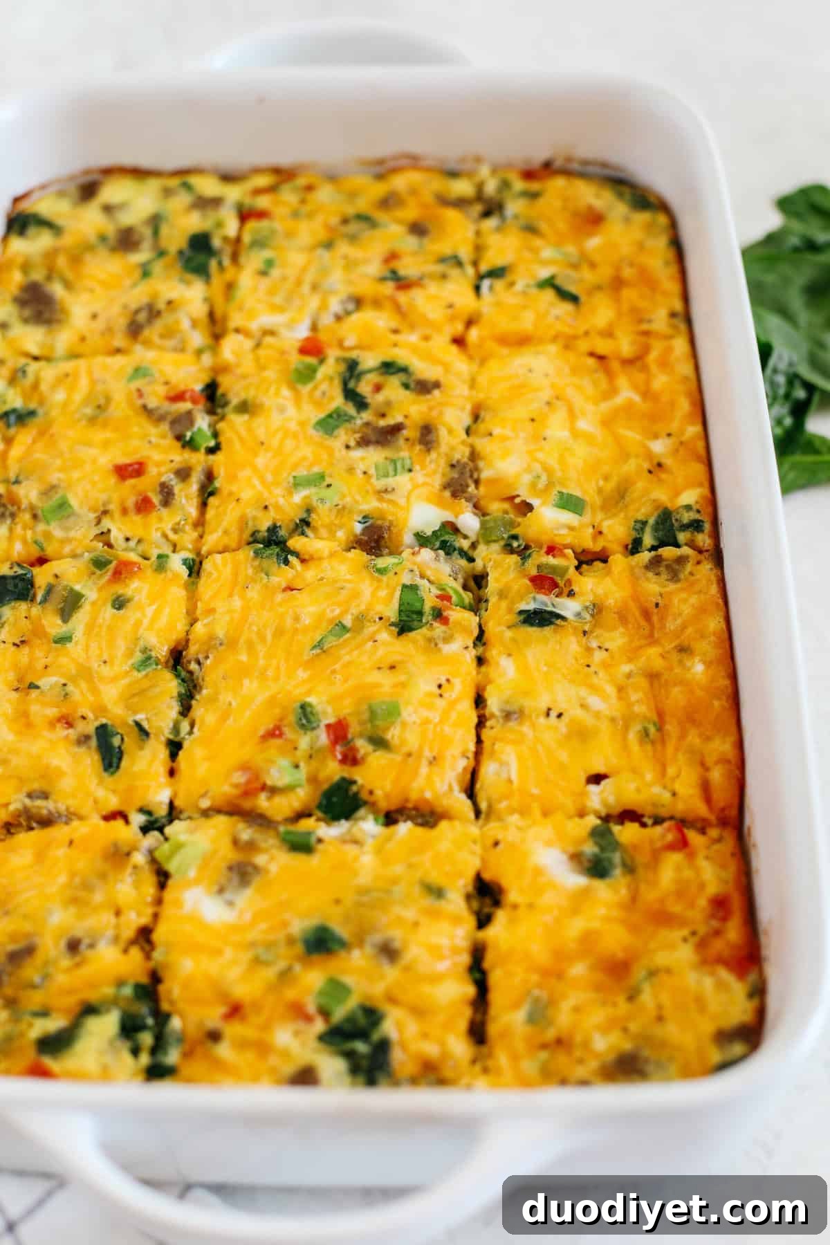Make Ahead Sausage and Vegetable Egg Casserole 4 Baked sausage and veggie egg casserole with golden edges and melted cheese.