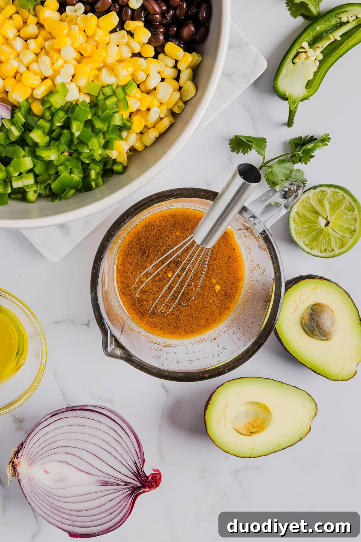 This Black Bean and Corn Salad is loaded with crisp veggies, delicious spices and fresh cilantro, all tossed together in a zesty lime dressing making it the perfect summer side dish or dip!