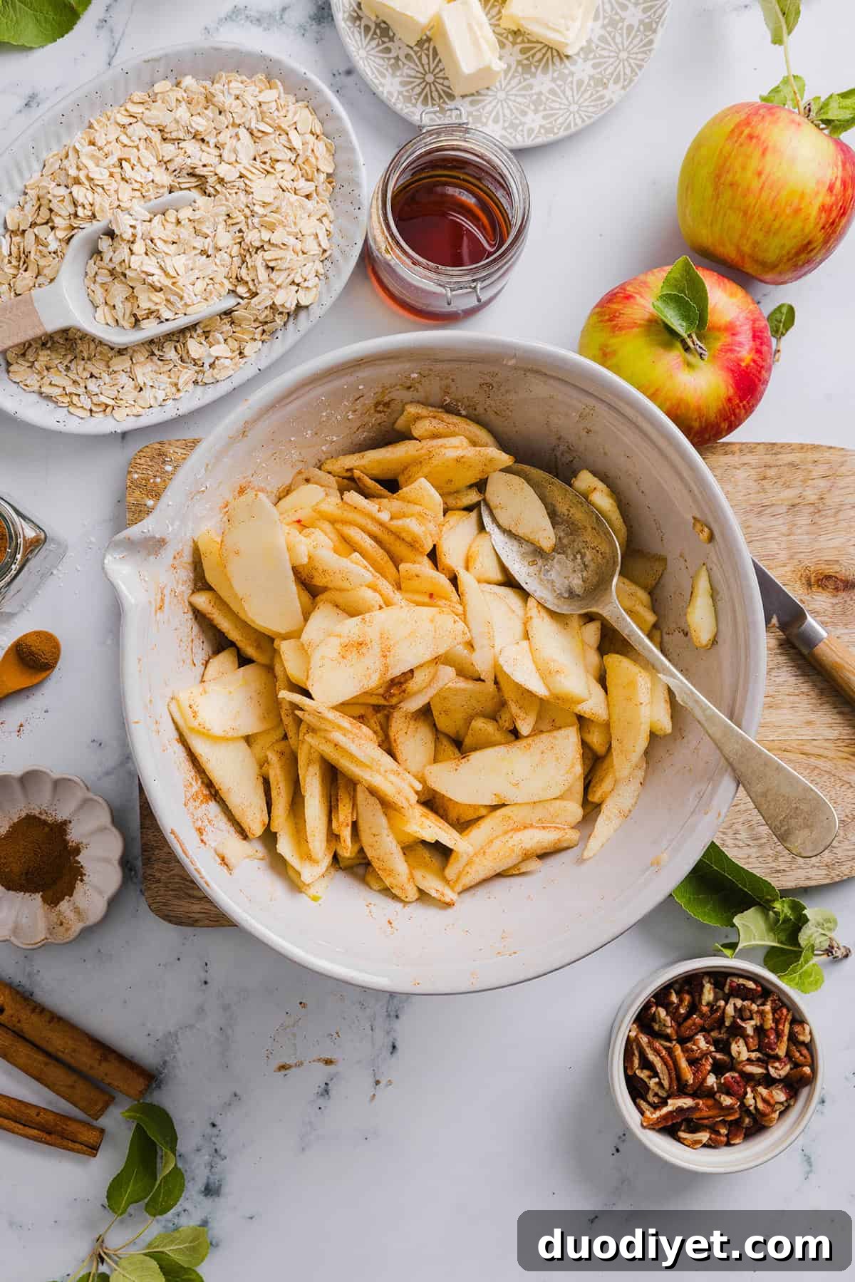 This Healthy Apple Crisp is loaded with tender apples and warm spices, naturally sweetened with maple syrup, all topped with a crunchy oatmeal pecan topping for the perfect fall dessert!