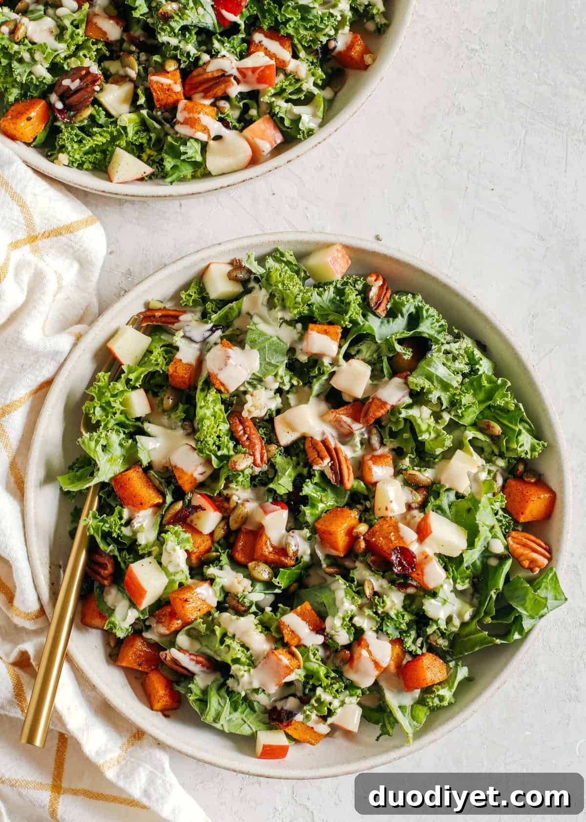 Autumn Harvest Salad with Maple Tahini Dressing 6 The ultimate powerhouse Fall Salad made with leafy kale, protein-packed quinoa, sliced apples, roasted butternut squash, and spiced pepitas and pecans, all drizzled in the most delicious maple tahini dressing!