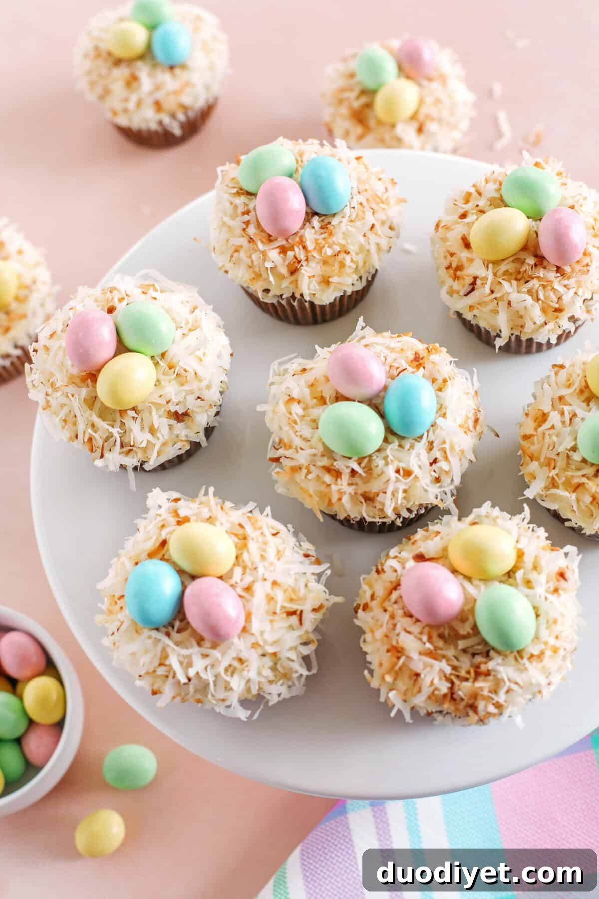 Cupcakes topped with toasted coconut and chocolate eggs
