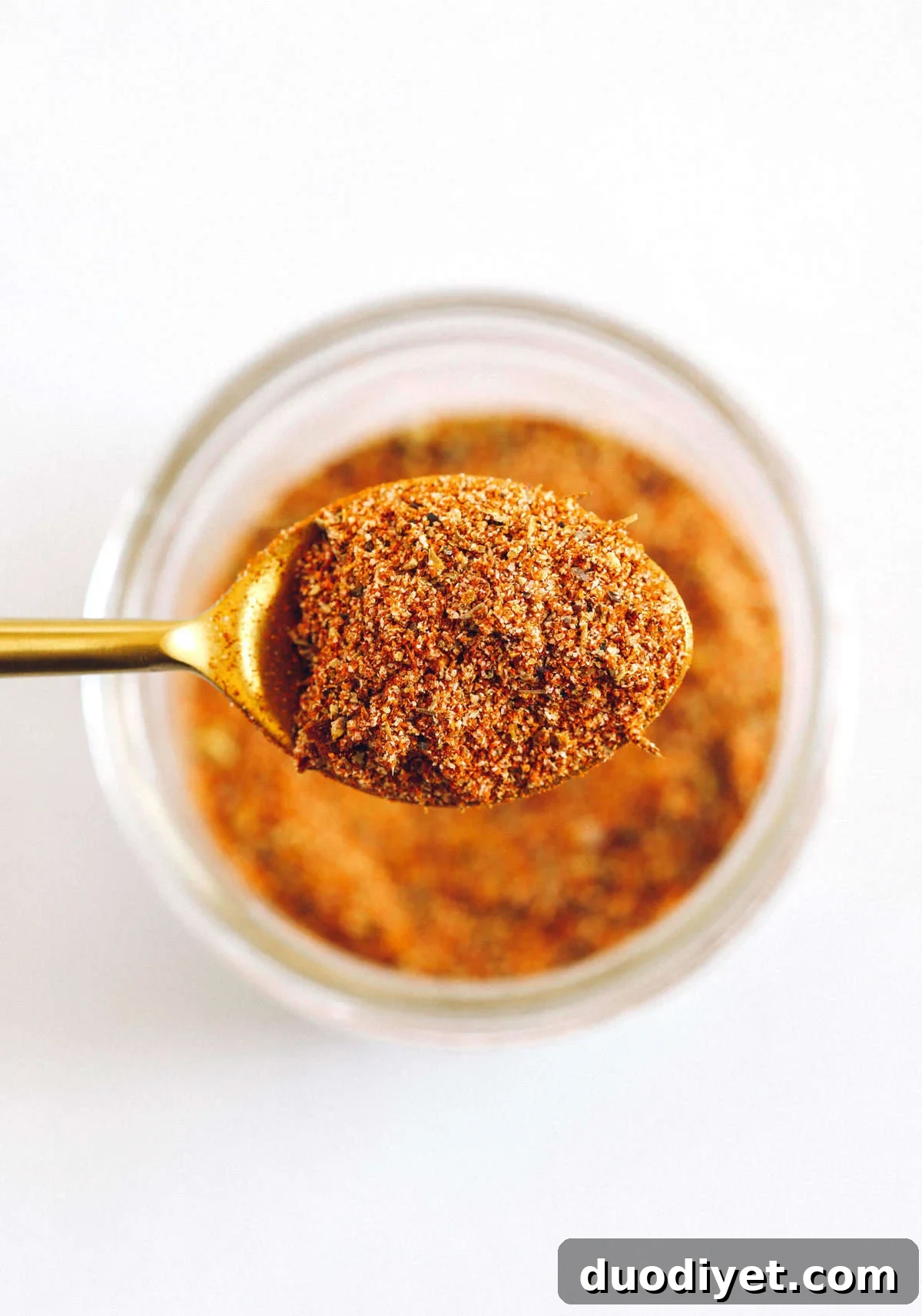 Jar of homemade Cajun seasoning next to dishes