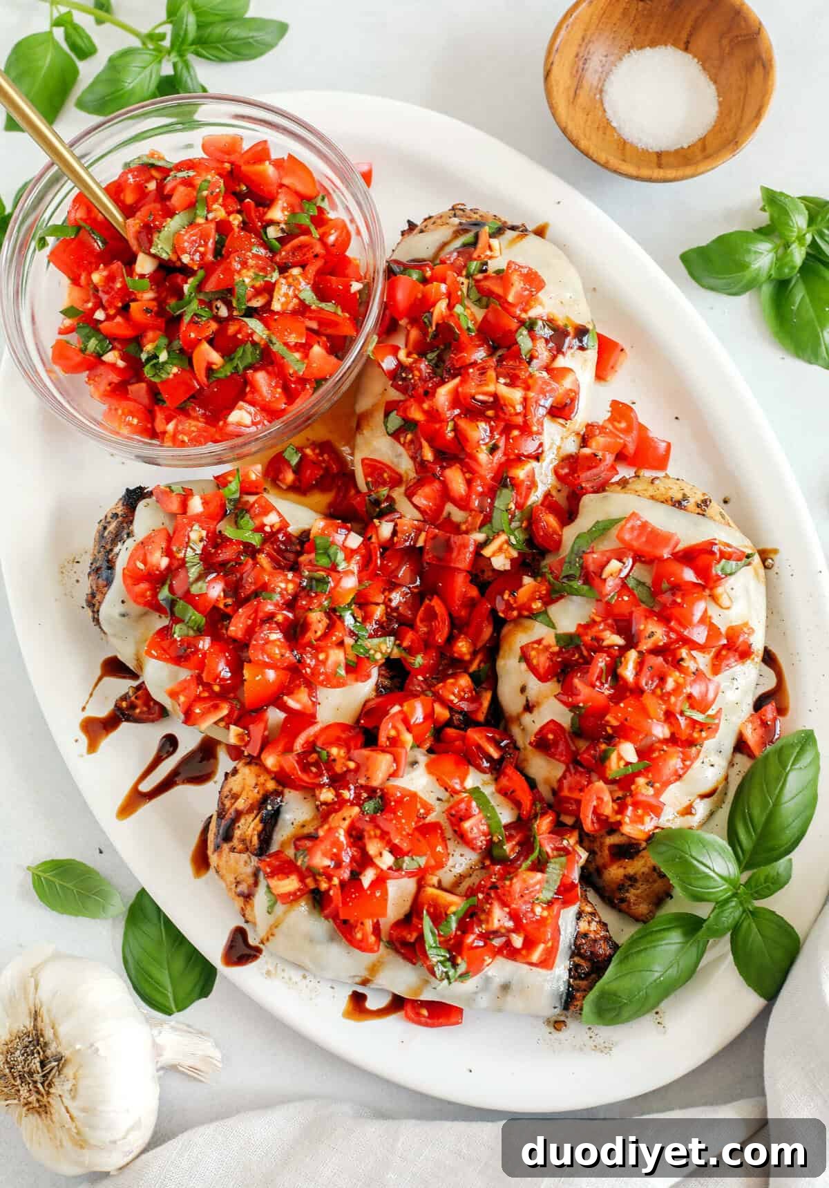 This Grilled Bruschetta Chicken is super easy to make and marinated in the most delicious lemon balsamic dressing all topped with melty mozzarella cheese and fresh tomato bruschetta for the perfect summer meal!