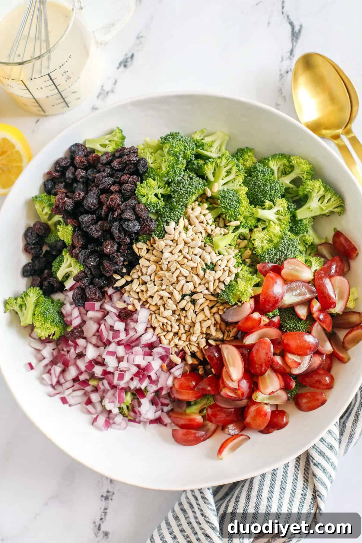 This Healthy Broccoli Salad is loaded with fresh broccoli, juicy grapes, red onion, crunchy sunflower seeds and raisins all tossed with a delicious zesty honey dijon dressing made with Greek yogurt instead of mayo!