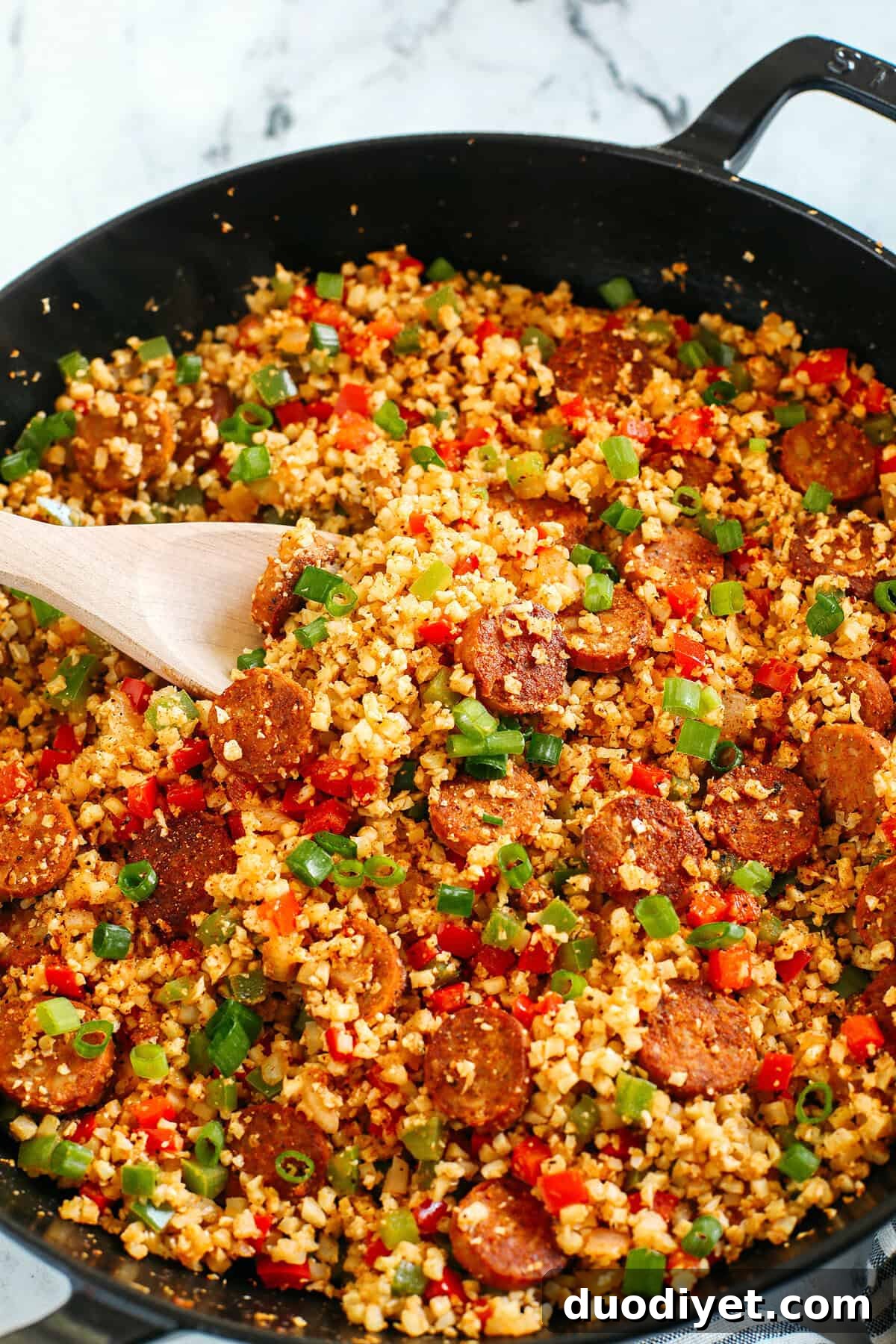 One-Skillet Cajun Sausage with Cauliflower Rice 3 Skillet full of Cajun sausage and cauliflower rice
