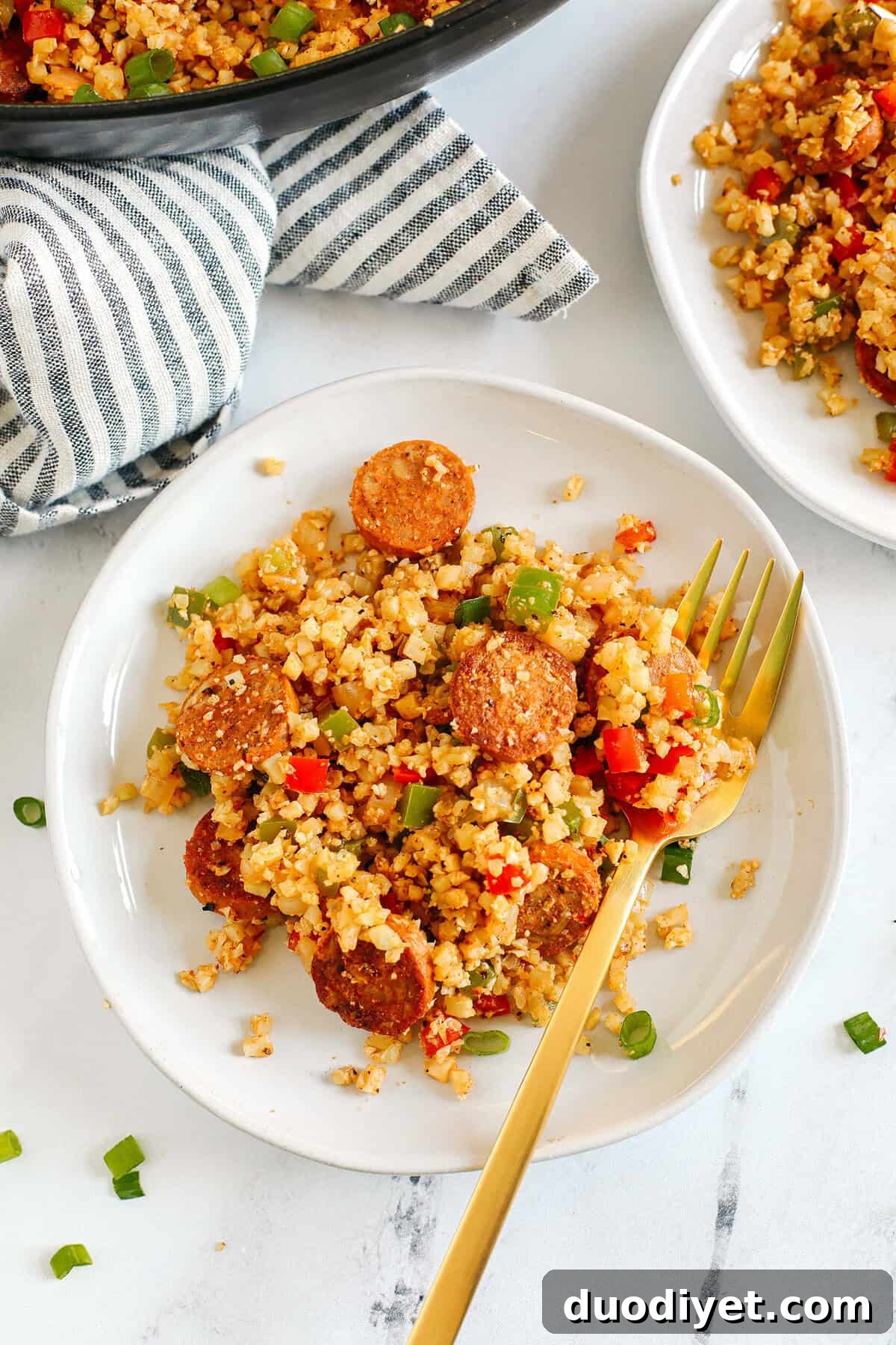 Cajun Sausage Skillet with Cauliflower Rice 4 Close up of Cajun Sausage and Cauliflower Rice Skillet with green onions
