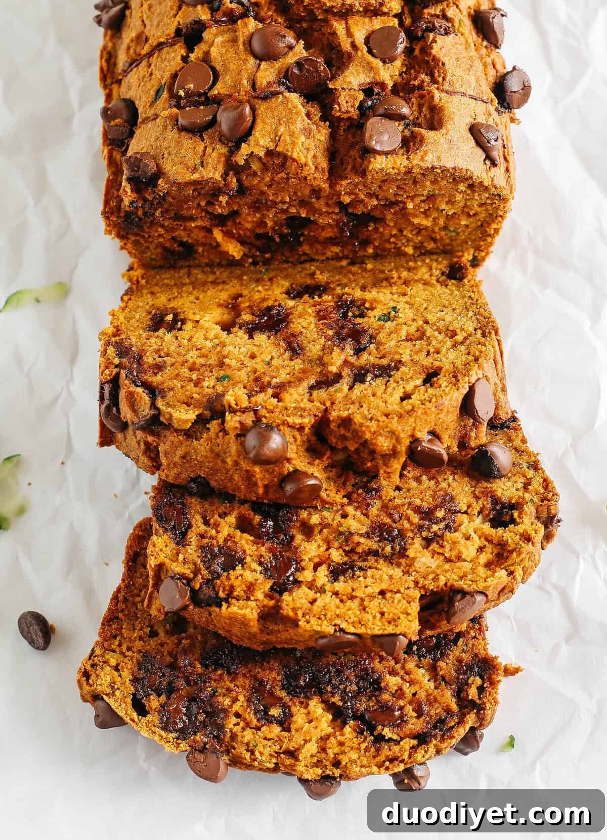 Healthy Pumpkin Zucchini Bread that is moist, fluffy and made healthier with whole wheat flour, Greek yogurt, shredded zucchini and zero butter or refined sugar. Loaded with warm flavors and studded with chunks of chocolate in every bite!