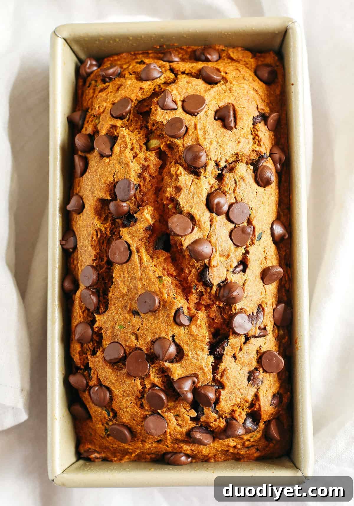 Healthy Pumpkin Zucchini Bread that is moist, fluffy and made healthier with whole wheat flour, Greek yogurt, shredded zucchini and zero butter or refined sugar. Loaded with warm flavors and studded with chunks of chocolate in every bite!