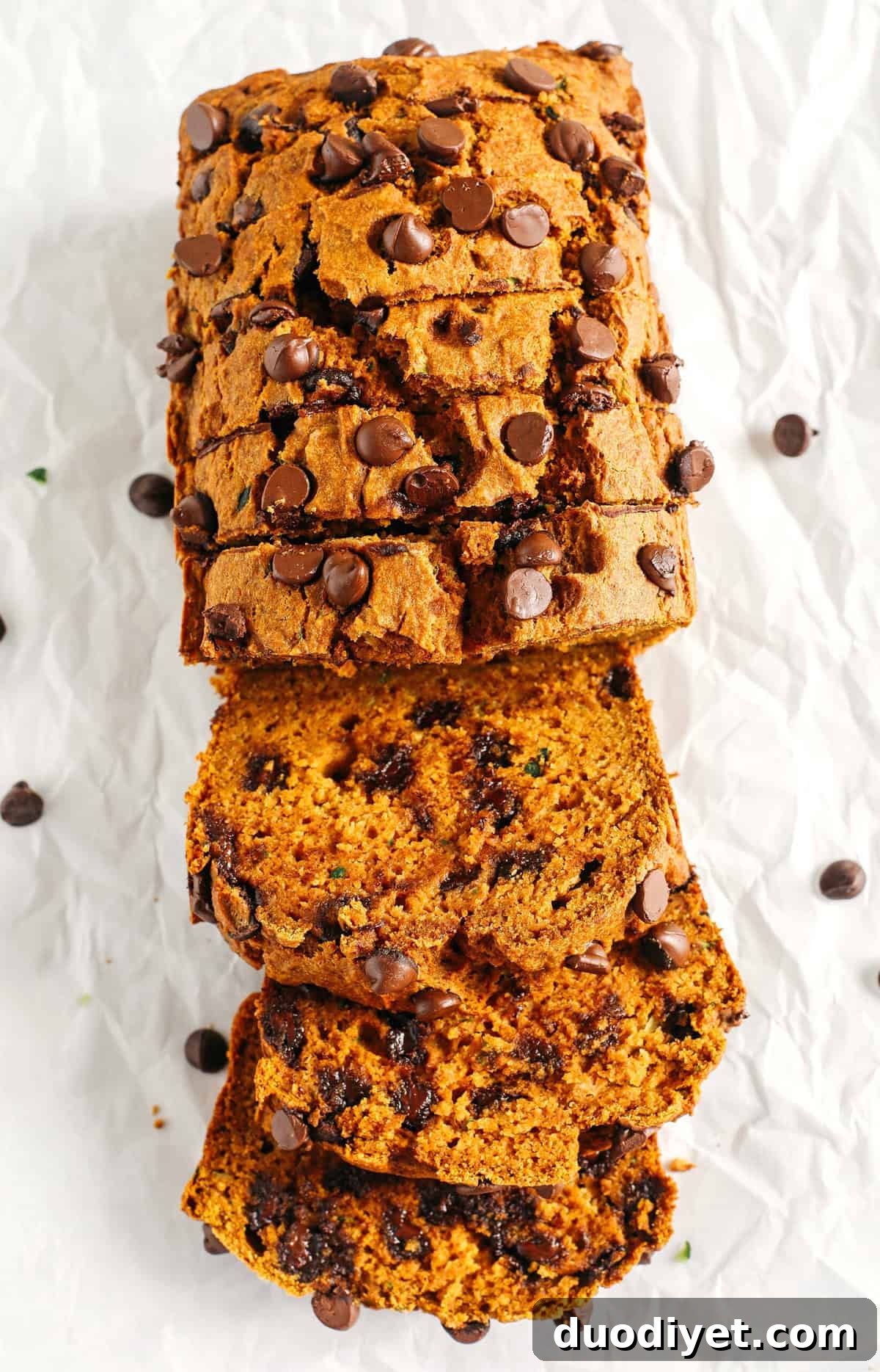 Healthy Pumpkin Zucchini Bread that is moist, fluffy and made healthier with whole wheat flour, Greek yogurt, shredded zucchini and zero butter or refined sugar. Loaded with warm flavors and studded with chunks of chocolate in every bite!