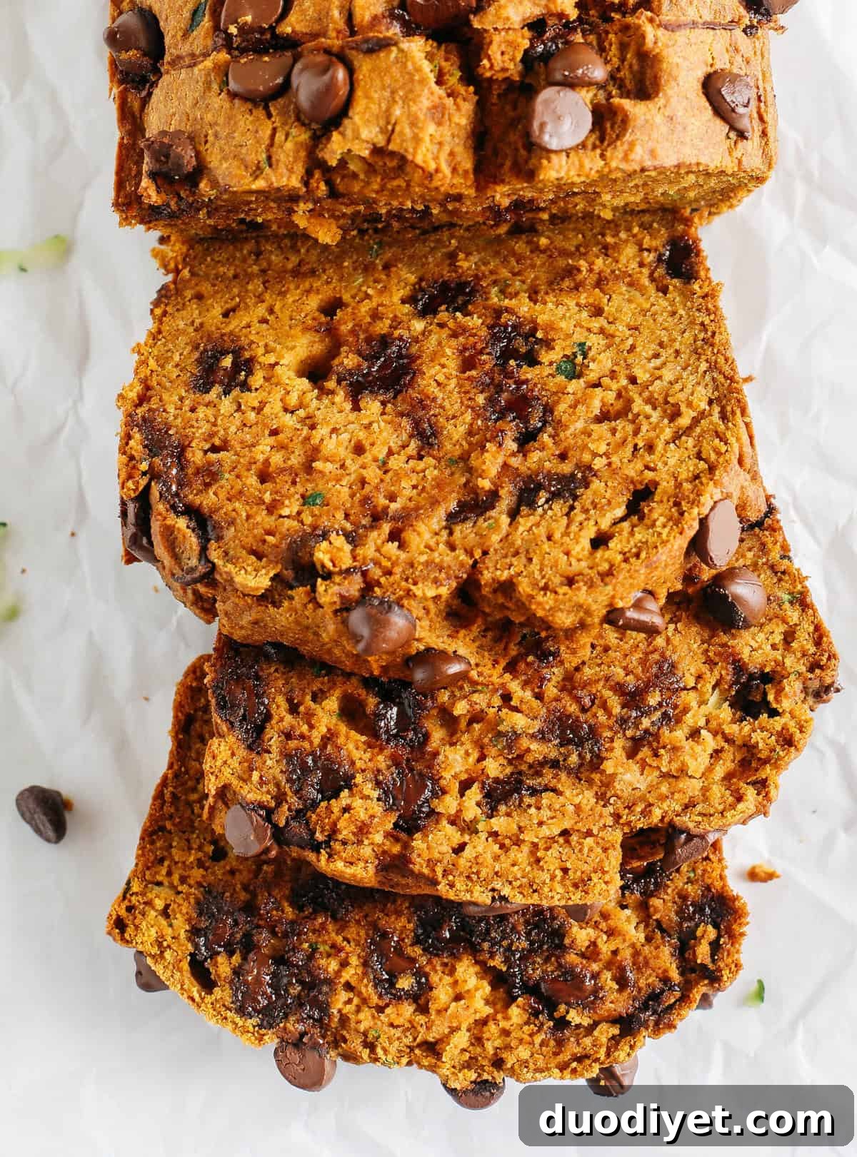 Healthy Pumpkin Zucchini Bread that is moist, fluffy and made healthier with whole wheat flour, Greek yogurt, shredded zucchini and zero butter or refined sugar. Loaded with warm flavors and studded with chunks of chocolate in every bite!