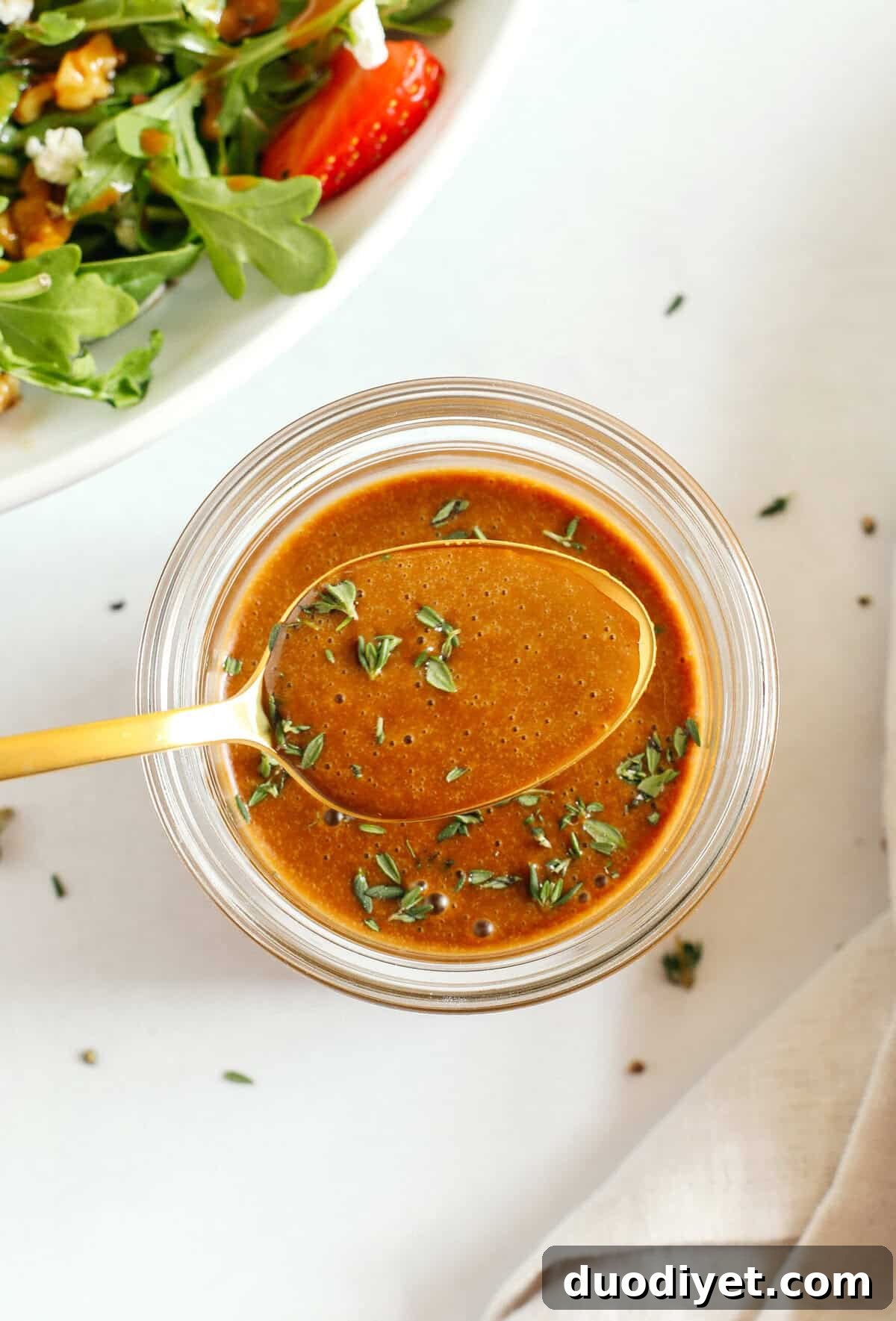 Maple Balsamic Herb Vinaigrette Recipe 3 Small bowl of Maple Balsamic Herb Dressing with fresh thyme
