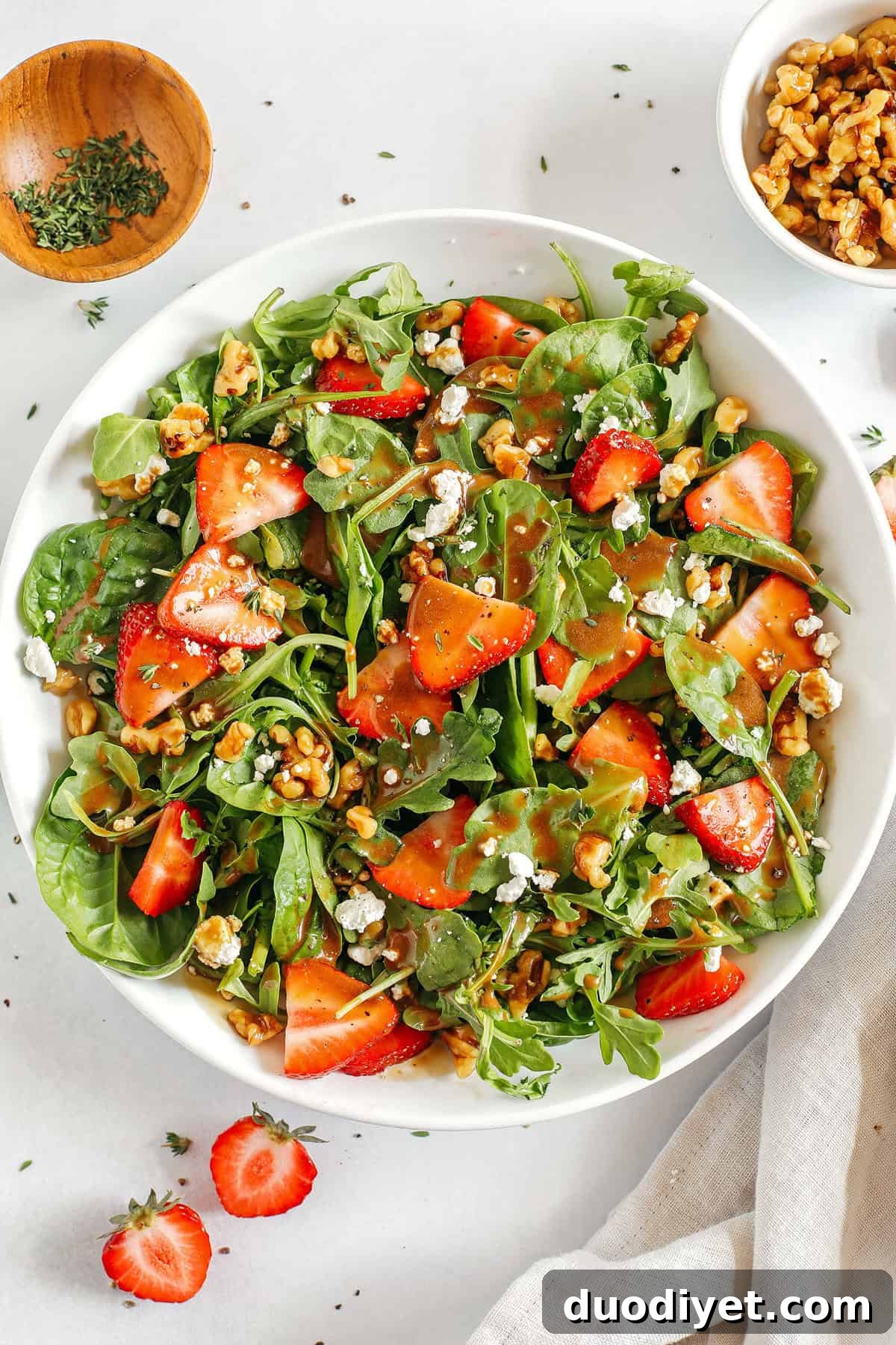 Strawberry Balsamic Salad with Goat Cheese and Arugula 2 My favorite Strawberry Salad made with leafy greens, fresh strawberries, candied walnuts, and creamy goat cheese all tossed with a rich and tangy maple balsamic dressing!