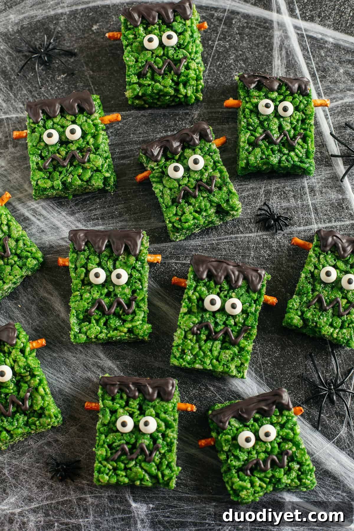Frankenstein bars being decorated with candy eyes and melted chocolate