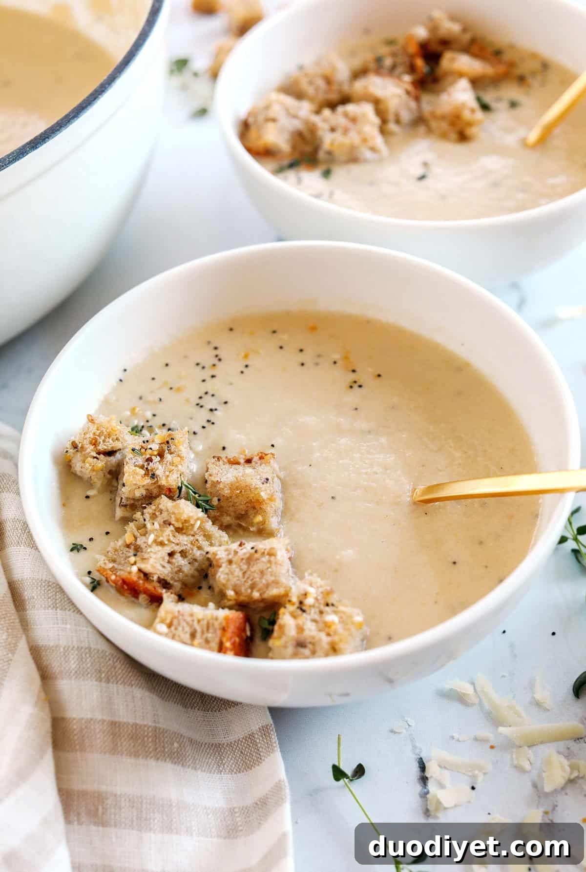 Creamy Cauliflower Soup topped with homemade seasoned croutons