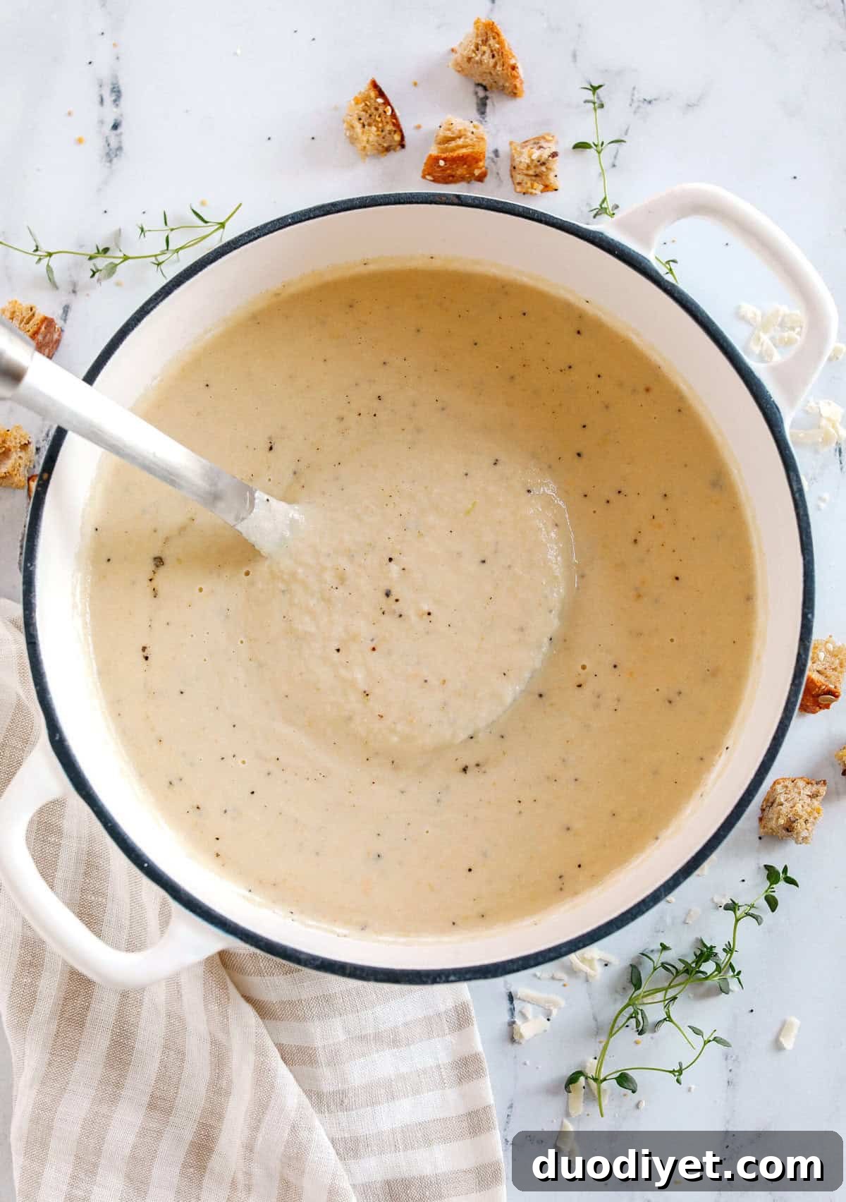 Creamy cauliflower soup in a bowl with croutons