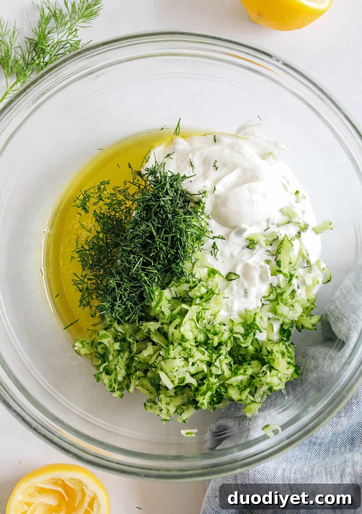 Fresh and flavorful Homemade Tzatziki Sauce is a creamy yogurt-based sauce perfect for the summer served with kabobs, grilled veggies, pita bread and more!  This recipe is easily made in just 5 minutes with a few simple ingredients!