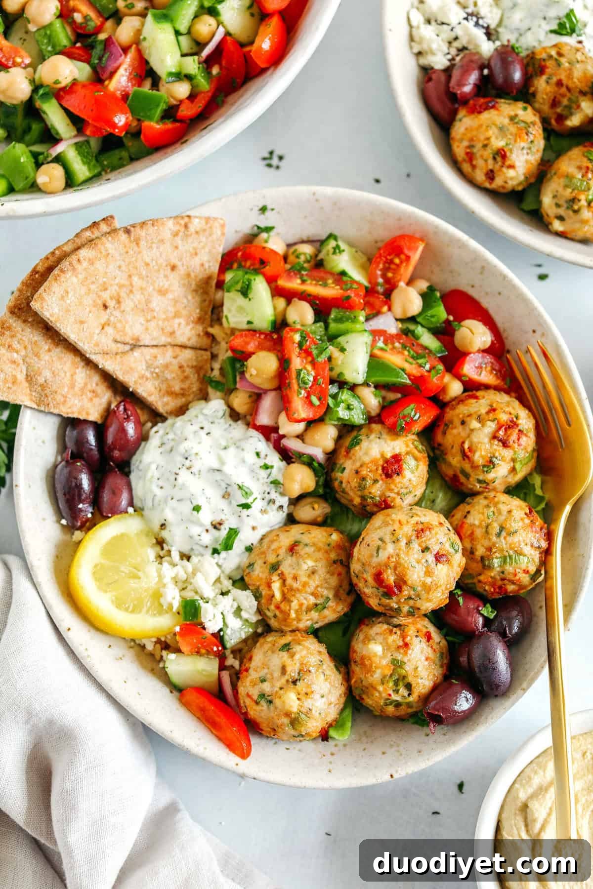 Mediterranean Chicken Meatballs ready to serve with tzatziki and rice