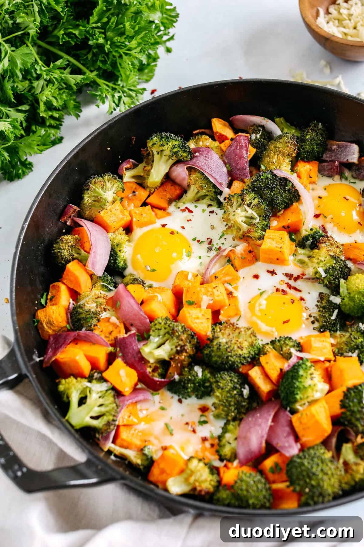Roasted Vegetable Breakfast Skillet with Eggs and Herbs 2 Roasted Veggie Breakfast Skillet made all in one pan with a hearty combination of sweet potatoes, broccoli and red onion topped with baked eggs and seasoned to perfection for a healthy delicious breakfast or dinner!