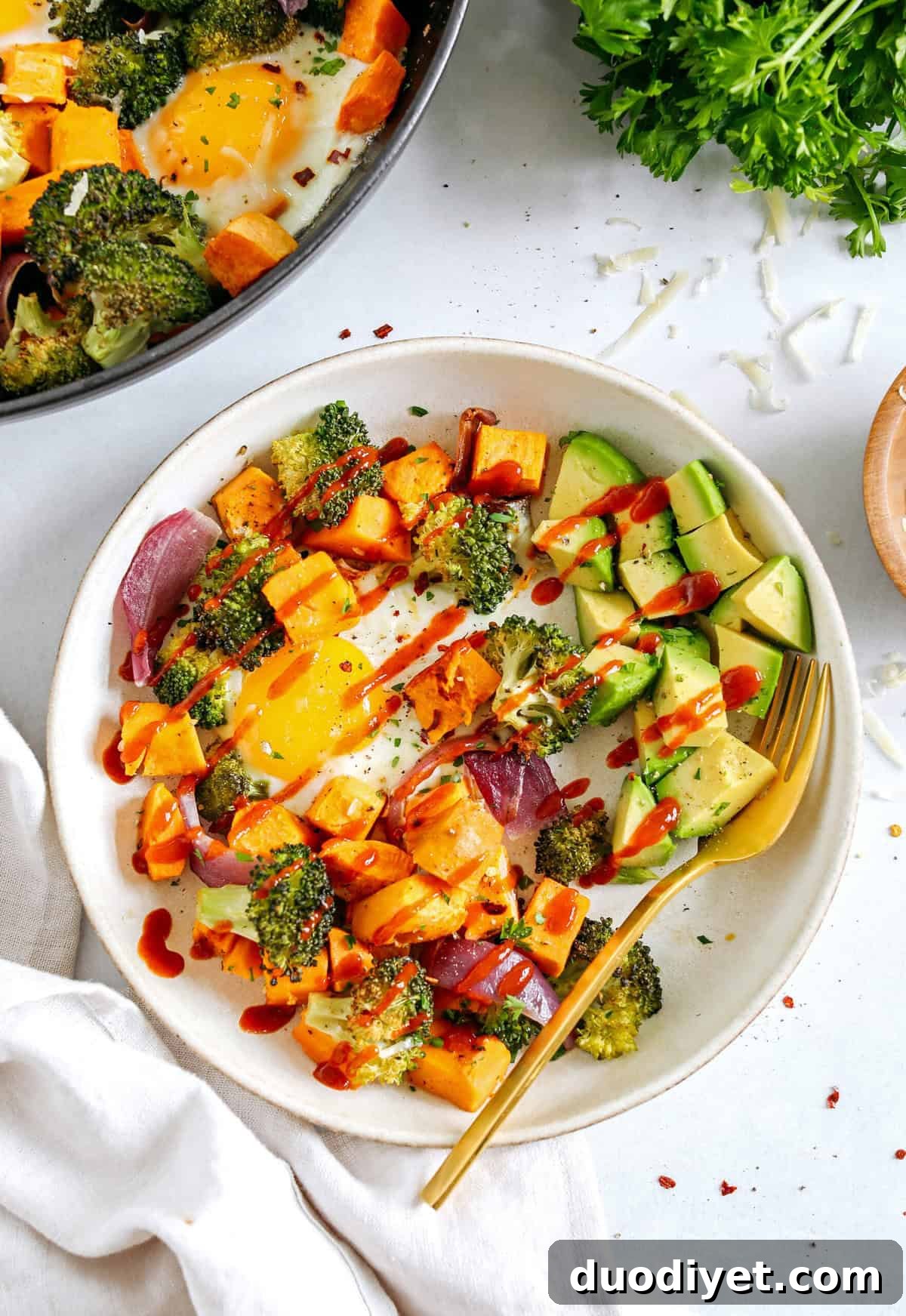 Roasted Vegetable Breakfast Skillet with Eggs and Herbs 4 Roasted Veggie Breakfast Skillet made all in one pan with a hearty combination of sweet potatoes, broccoli and red onion topped with baked eggs and seasoned to perfection for a healthy delicious breakfast or dinner!