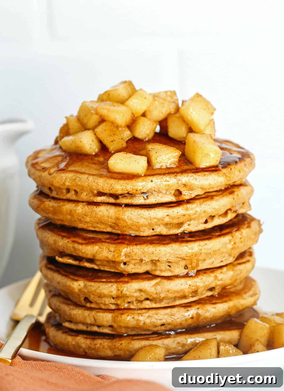Light and fluffy Apple Cinnamon Pancakes made healthier with whole wheat flour, applesauce in place of oil and zero butter or refined sugar! Topped with warm spiced apples and drizzled with maple syrup!