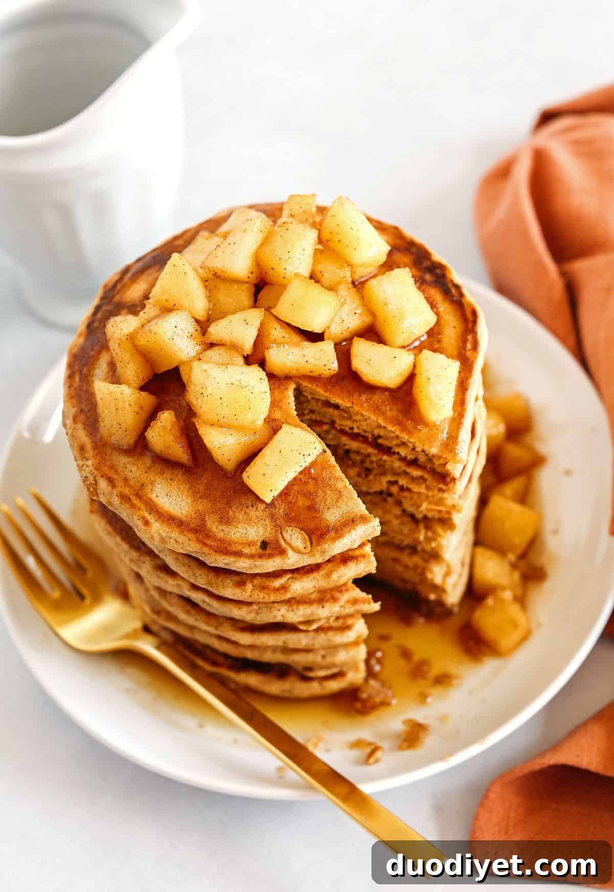 Light and fluffy Apple Cinnamon Pancakes made healthier with whole wheat flour, applesauce in place of oil and zero butter or refined sugar! Topped with warm spiced apples and drizzled with maple syrup!