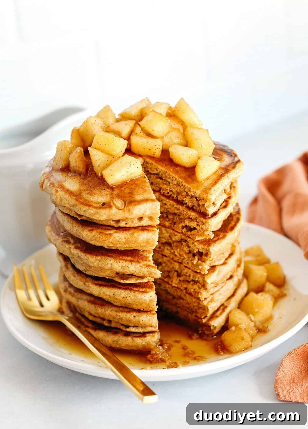 Light and fluffy Apple Cinnamon Pancakes made healthier with whole wheat flour, applesauce in place of oil and zero butter or refined sugar! Topped with warm spiced apples and drizzled with maple syrup!