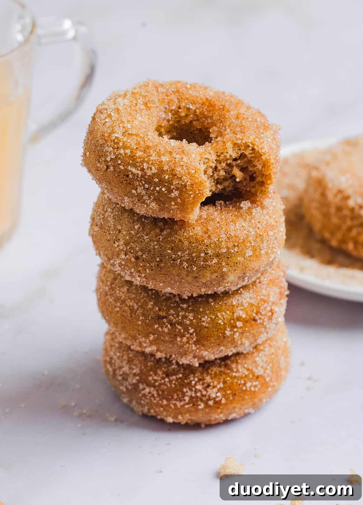 Stack of baked apple cider donuts with cinnamon sugar dusting