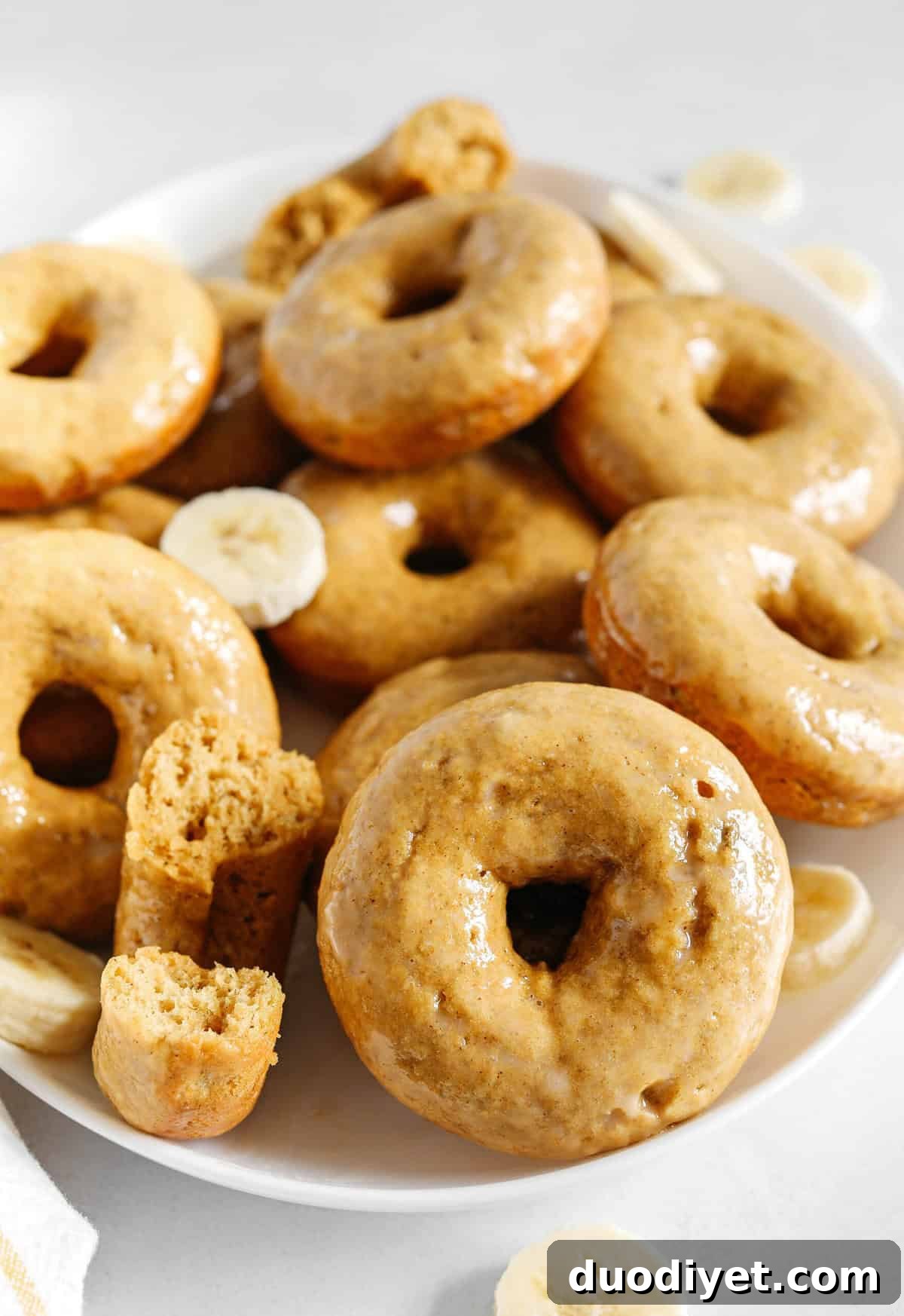 These Baked Banana Bread Donuts are soft, cake-like and made healthier with whole wheat flour, applesauce and zero refined sugar for the perfect morning treat that comes together in just 20 minutes! Such a great way to use up those overripe bananas!