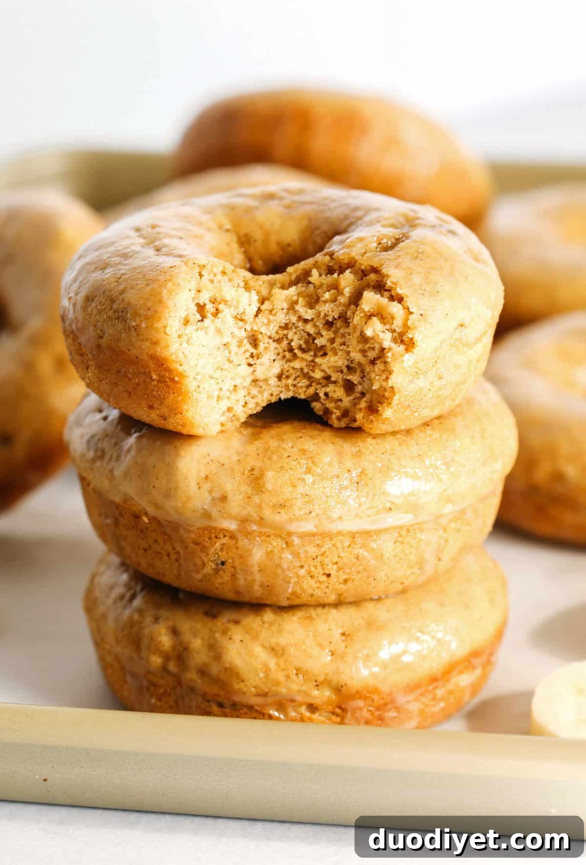 These Baked Banana Bread Donuts are soft, cake-like and made healthier with whole wheat flour, applesauce and zero refined sugar for the perfect morning treat that comes together in just 20 minutes! Such a great way to use up those overripe bananas!