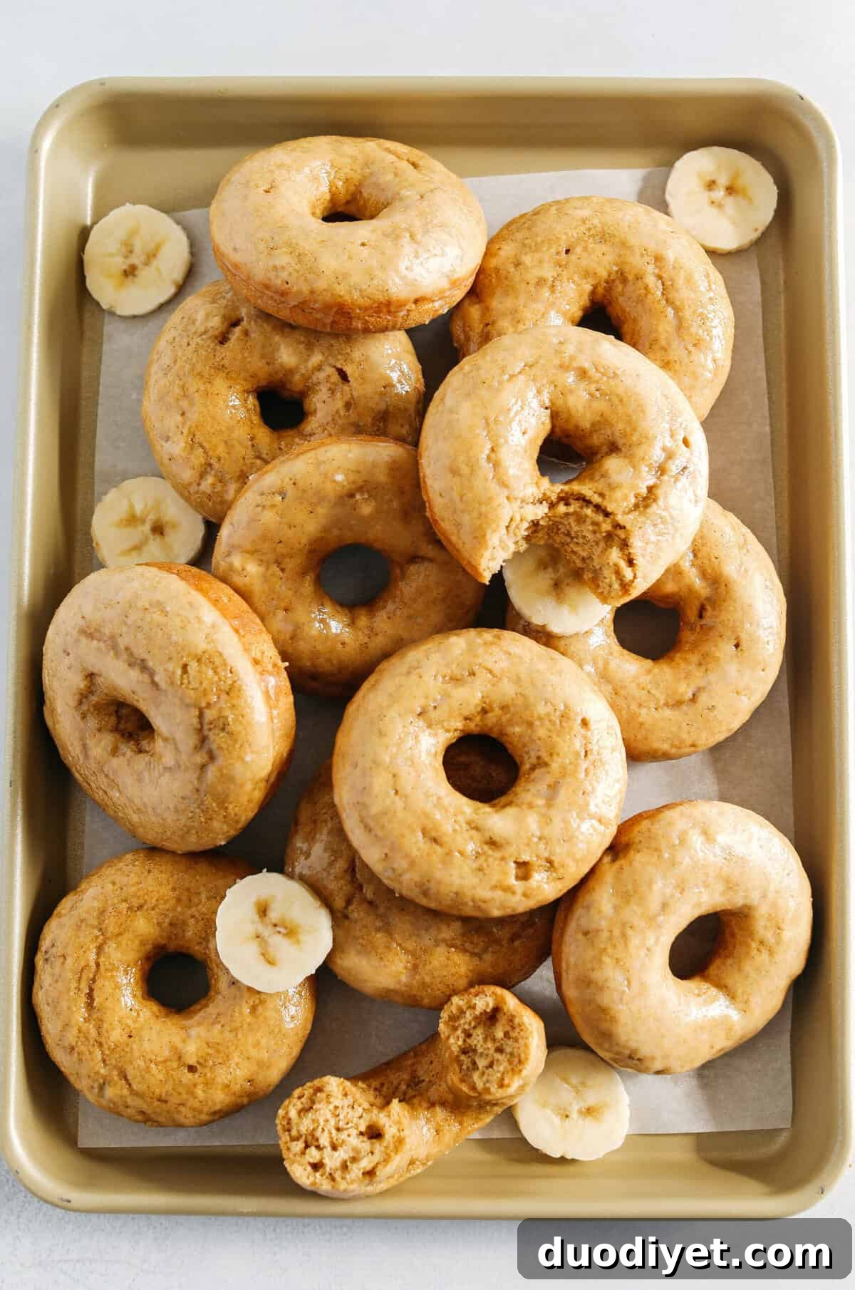 These Baked Banana Bread Donuts are soft, cake-like and made healthier with whole wheat flour, applesauce and zero refined sugar for the perfect morning treat that comes together in just 20 minutes! Such a great way to use up those overripe bananas!