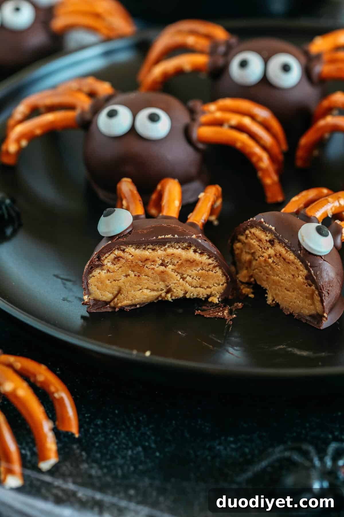 Chocolate Peanut Butter Spider Truffles for Halloween 5 Decorating the spider balls with pretzel legs and candy eyes