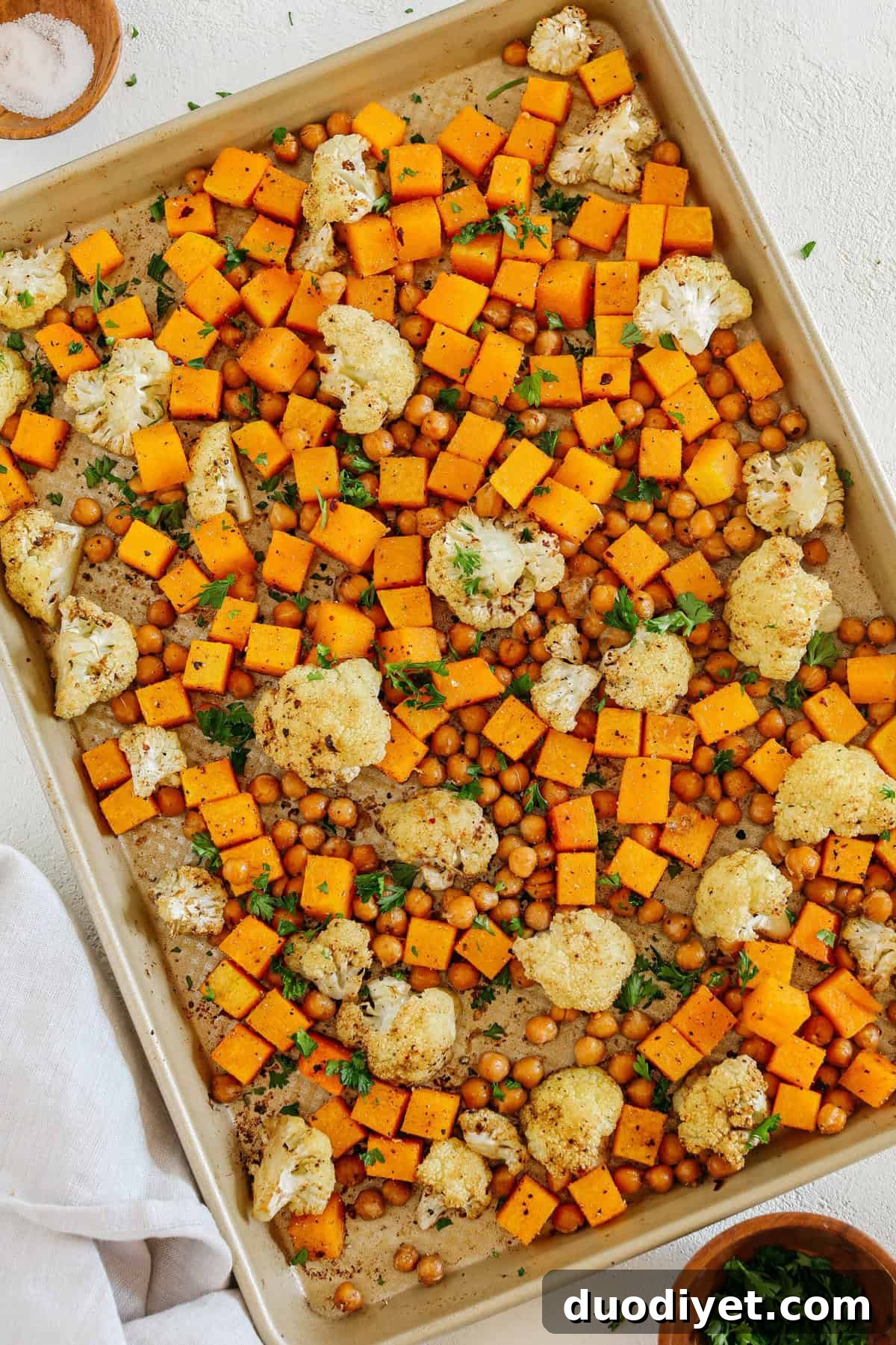 Roasted Squash, Cauliflower and Chickpeas that are perfectly seasoned and cooked all on one sheet pan for an easy and delicious healthy side dish the whole family will love!
