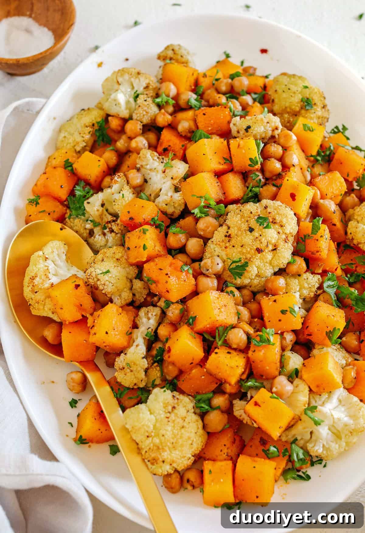 Roasted Squash, Cauliflower and Chickpeas that are perfectly seasoned and cooked all on one sheet pan for an easy and delicious healthy side dish the whole family will love!