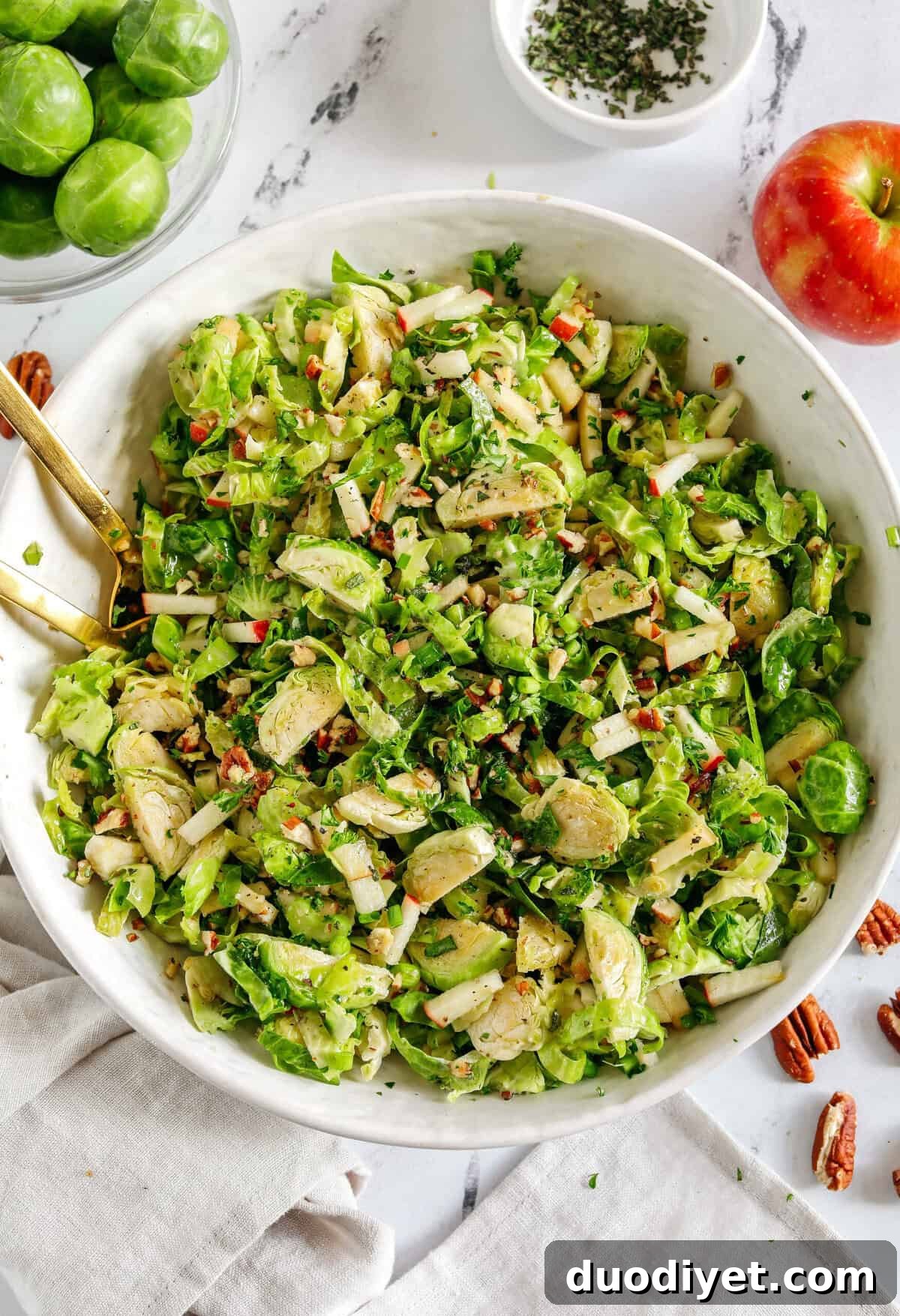 Close-up of fall brussels sprout salad with pecans and herbs