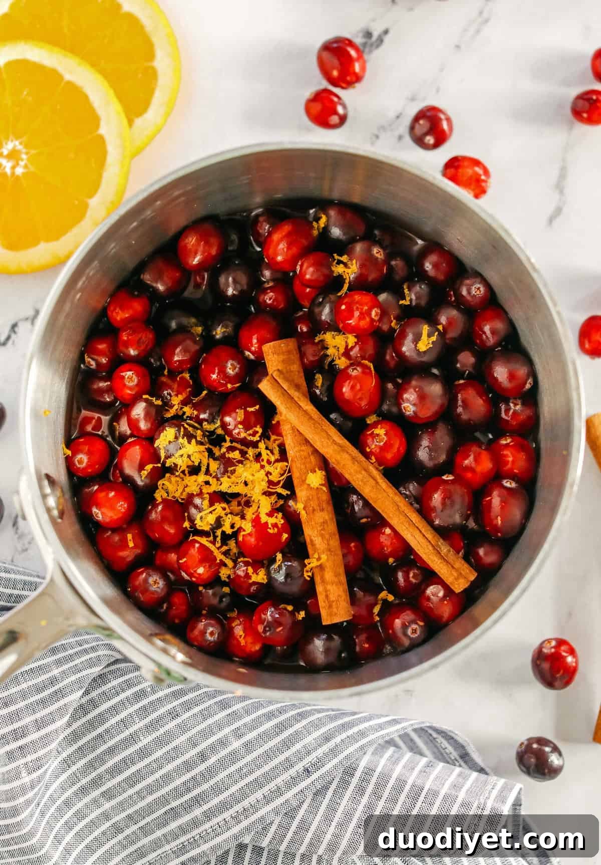 Low-Sugar Cranberry Sauce with Orange and Maple 3 Cranberry sauce in a serving bowl with orange zest