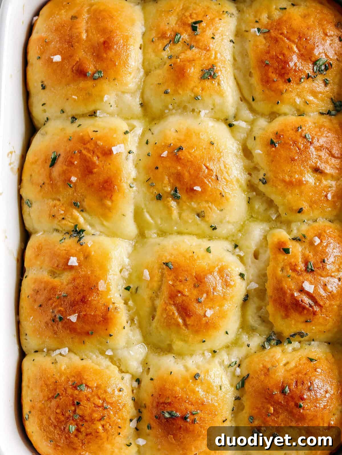 Soft Homemade Honey Butter Dinner Rolls Recipe 2 Pull-apart Honey Butter Dinner Rolls, golden and fluffy, finished with honey and fresh herbs.