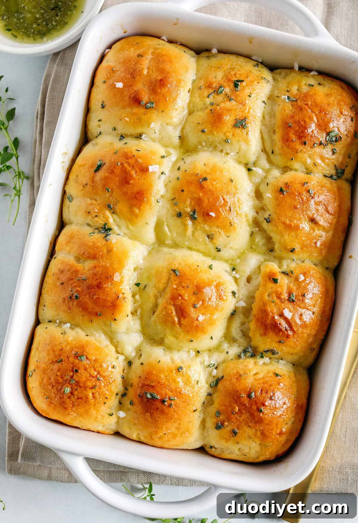 Soft Homemade Honey Butter Dinner Rolls Recipe 5 Golden honey butter dinner rolls stacked on a plate, ready to serve.