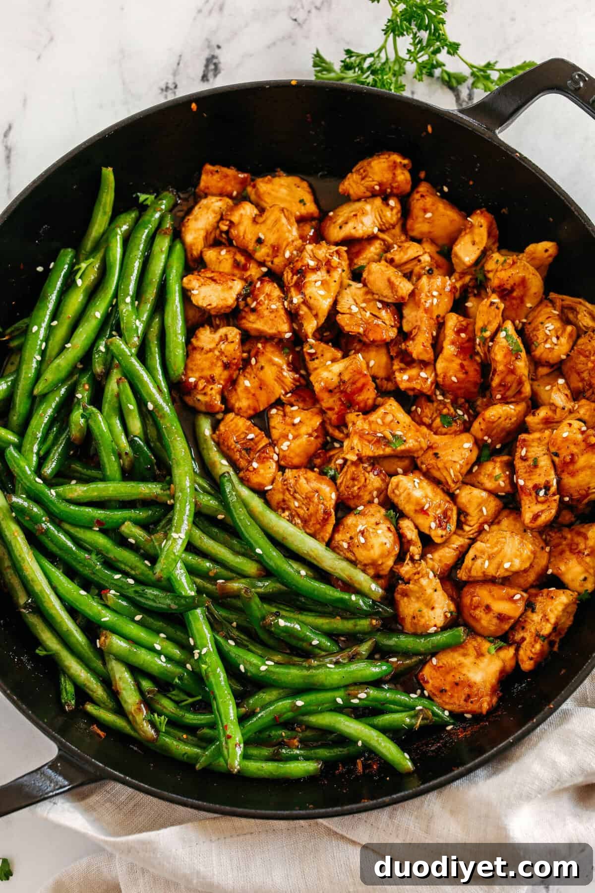 Super flavorful Honey Garlic Chicken and Green Beans make the perfect weeknight meal smothered in a delicious sauce that tastes way better than take-out!  Serve over rice and have dinner on your table in under 30 minutes! 
