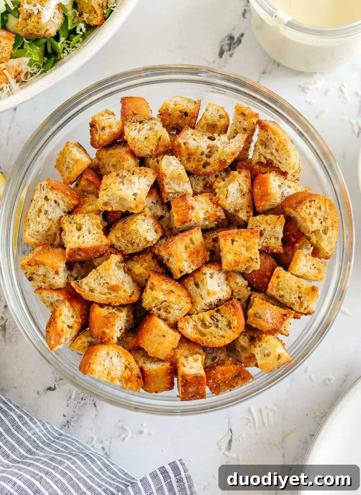 Learn how to make Easy Homemade Croutons that are crispy, garlicky and super quick to make! Use them as a topping for salads, soups, stuffing and more!