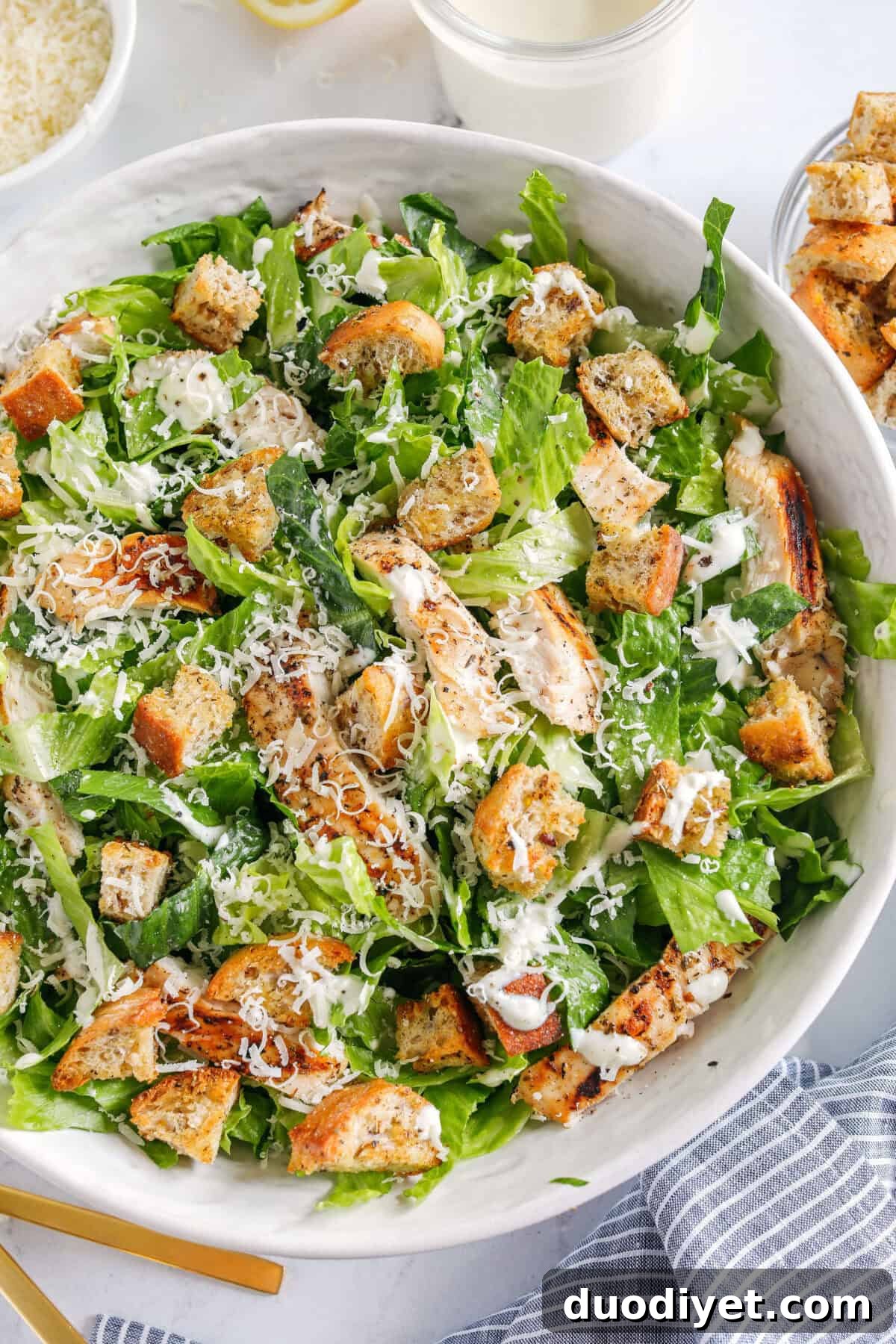 The BEST Healthy Chicken Caesar Salad made with grilled lemon chicken, garlicky homemade croutons, fresh parmesan cheese and tossed with a lightened up Greek yogurt dressing!