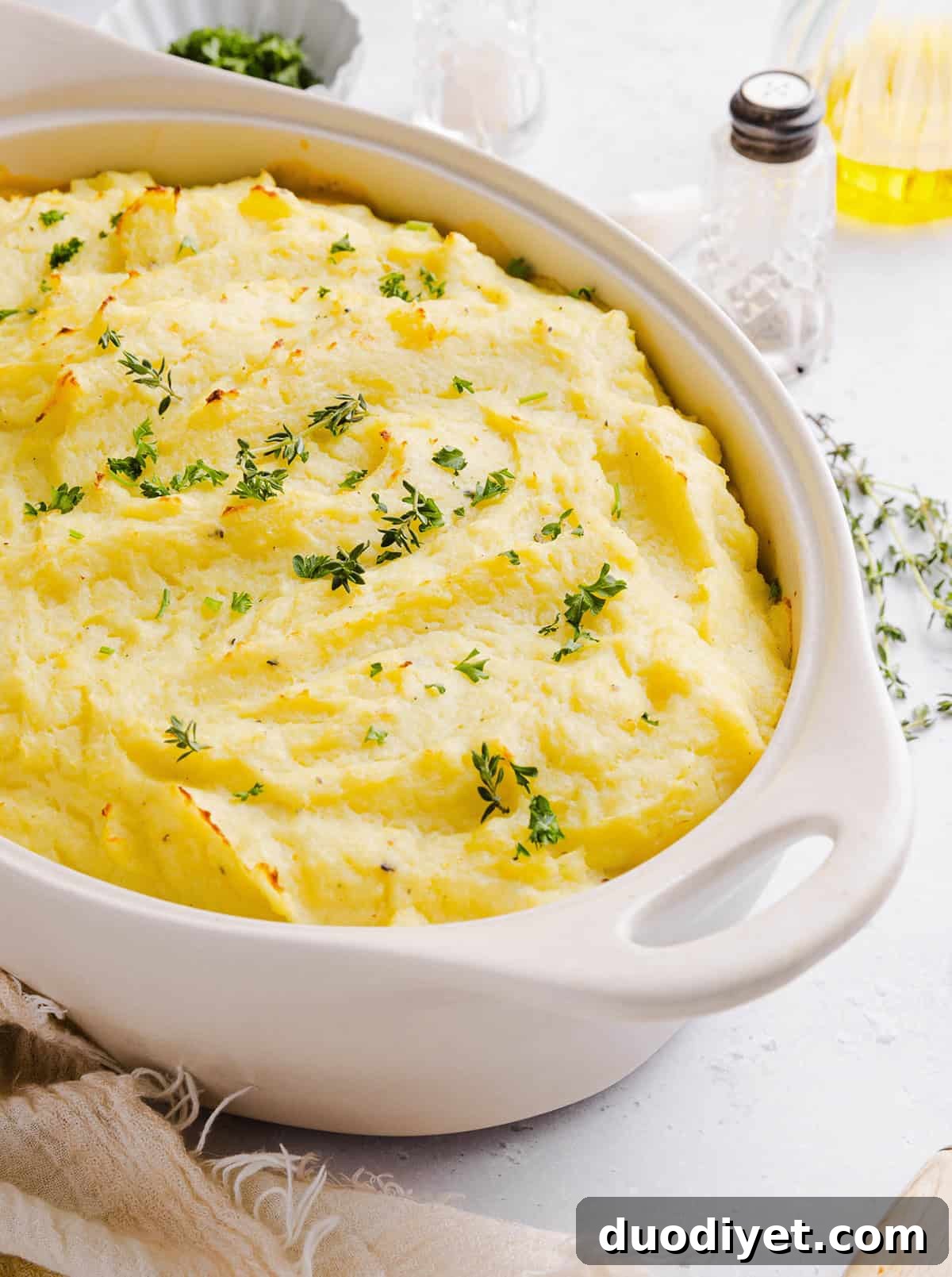 Turkey Shepherd's Pie with Mashed Potato and Veggies 6 Golden baked shepherd's pie with herbs on top.