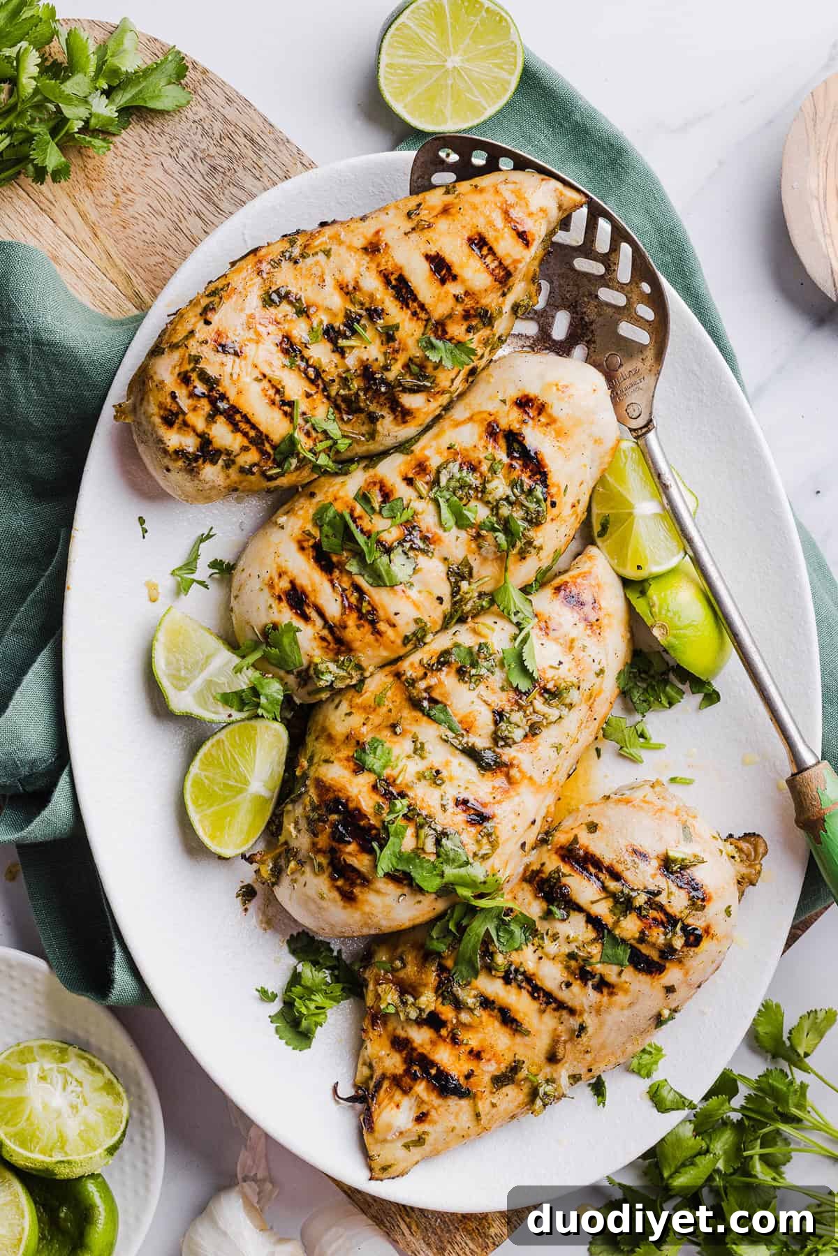 Resting grilled chicken with cilantro garnish